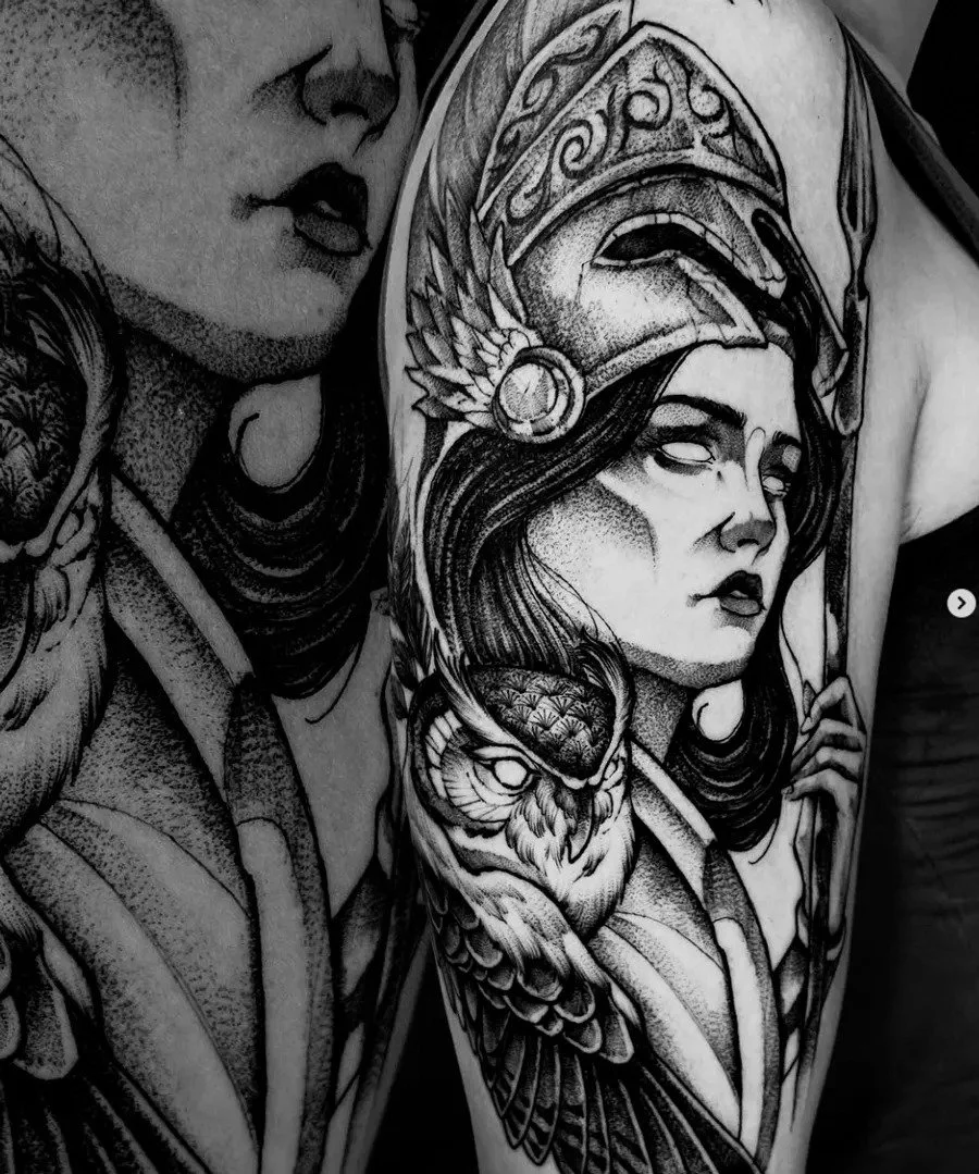 Black-and-gray female warrior and owl arm tattoo.