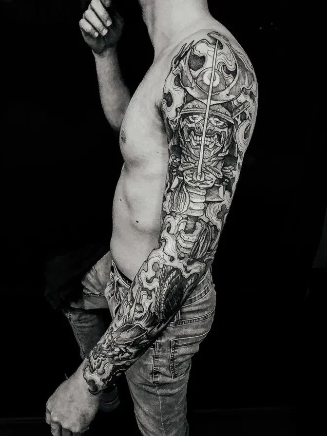 Black-and-gray Japanese warrior full sleeve tattoo.