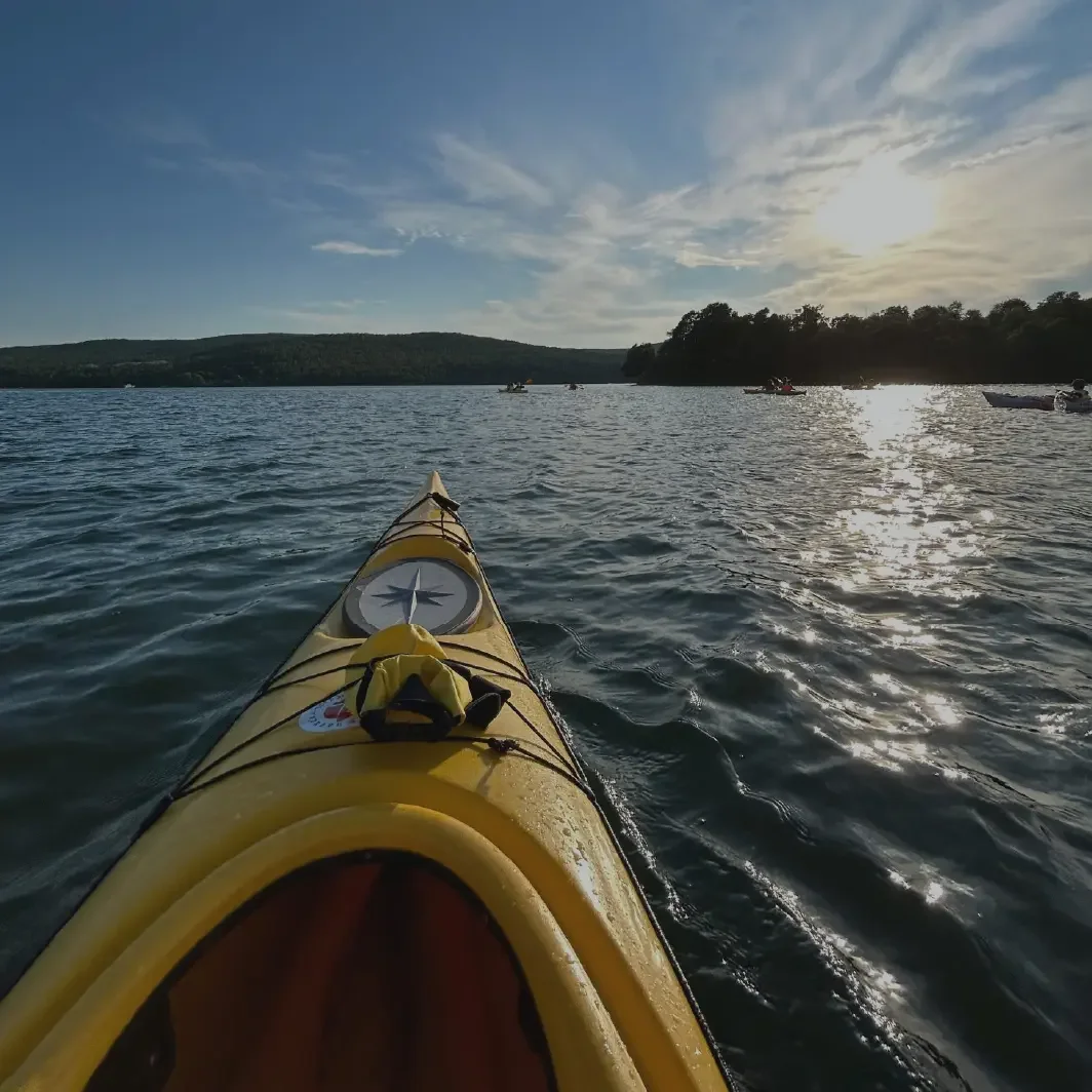 A person kayaking on the calm Adriatic sea near Zadar at golden hour.