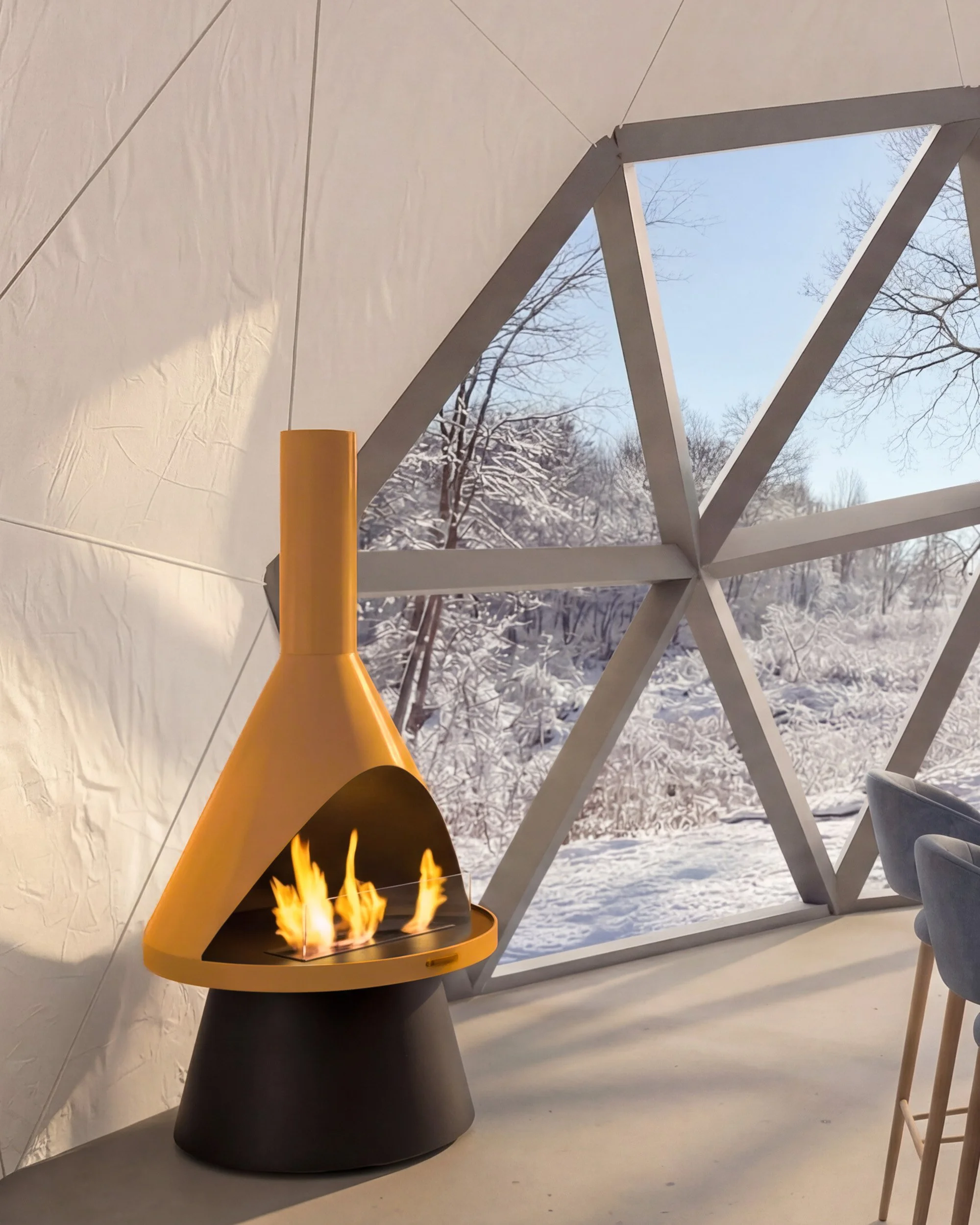 A modern fireplace with a yellow top and black base inside a geometric tent-like structure with large window showing a snowy winter landscape.