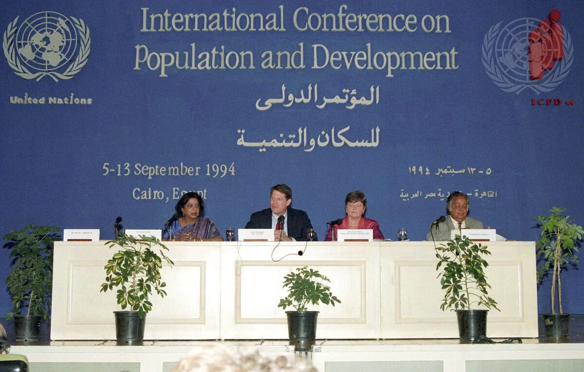 A panel of four people seated at a long table with microphones during the International Conference on Population and Development in Cairo, Egypt, held from September 5-13, 1994.