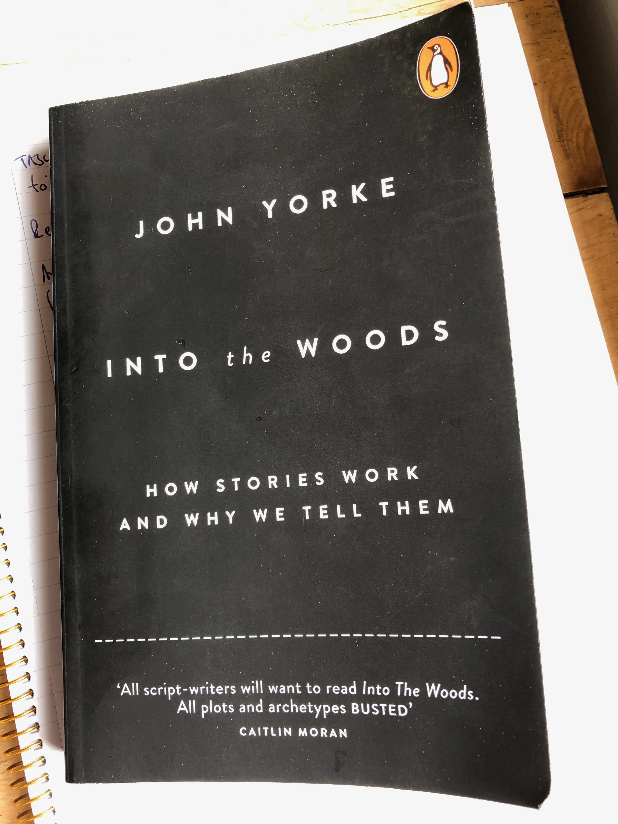 Book titled "Into the Woods" by John Yorke, with a black cover and white text, and a Penguin logo in the top right corner.