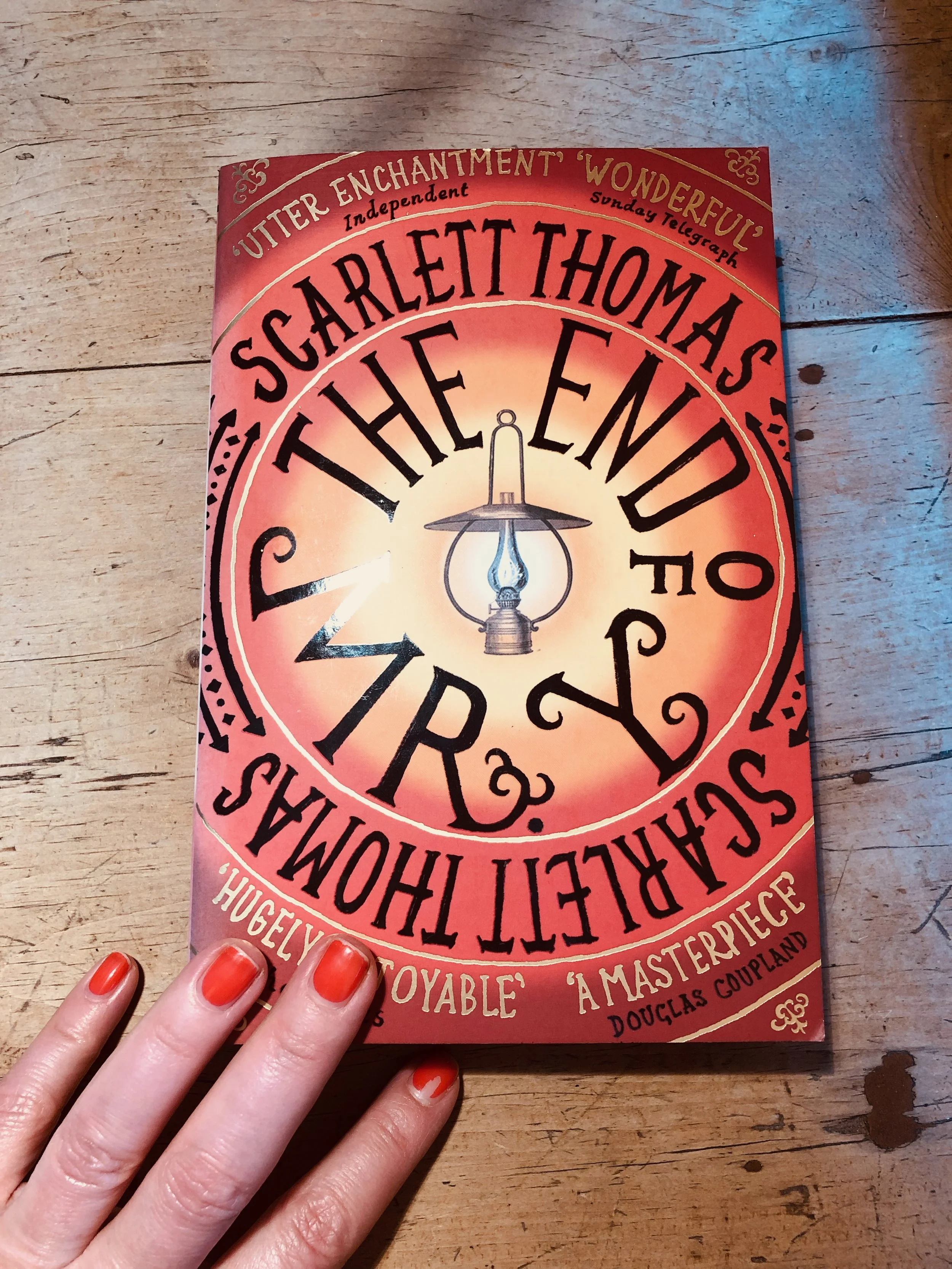 Front cover of a book titled "The End of Mr. Y" by Scarlett Thomas, featuring an illustration of a vintage lantern against a glowing background.