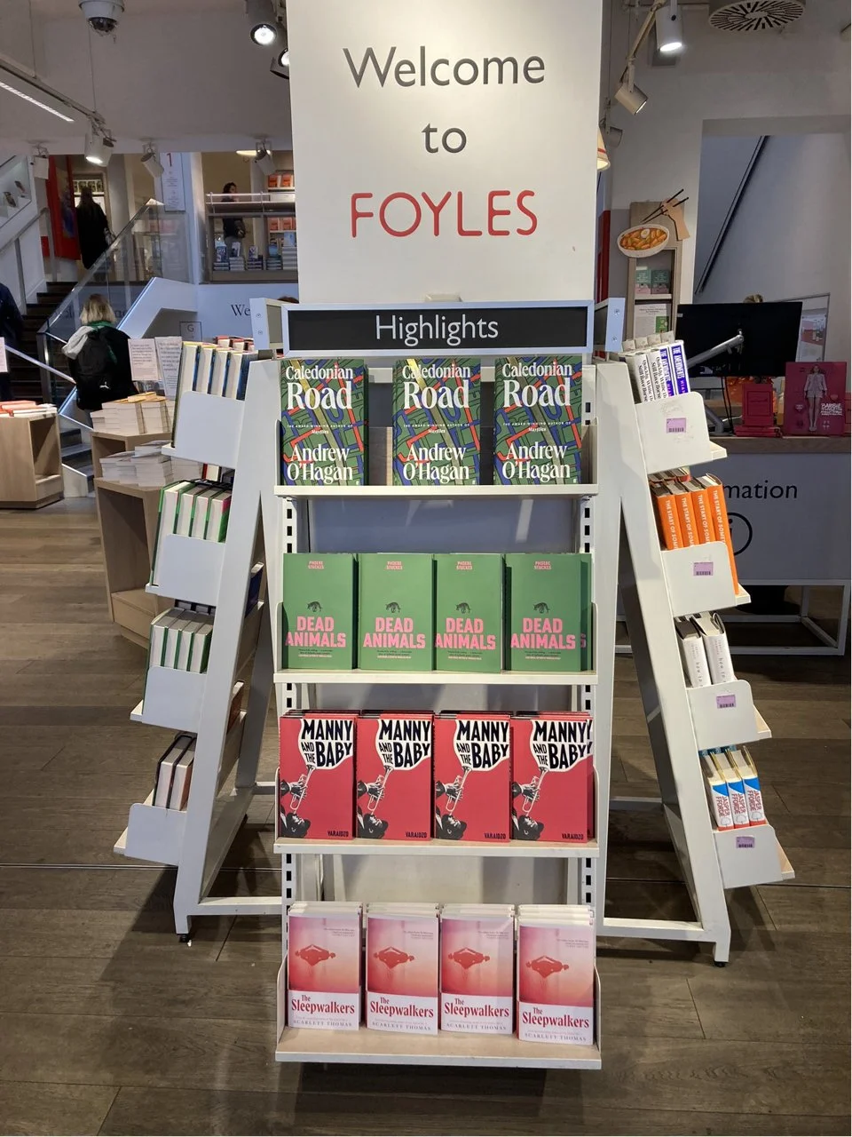 Books display shelf at Foyles bookstore with three books titled 'Caledonian Road' by Andrew O'Hagan at the top, followed by 'Dead Animals,' 'Manny and the Baby,' and 'The Sleepwalkers' on the lower shelves.