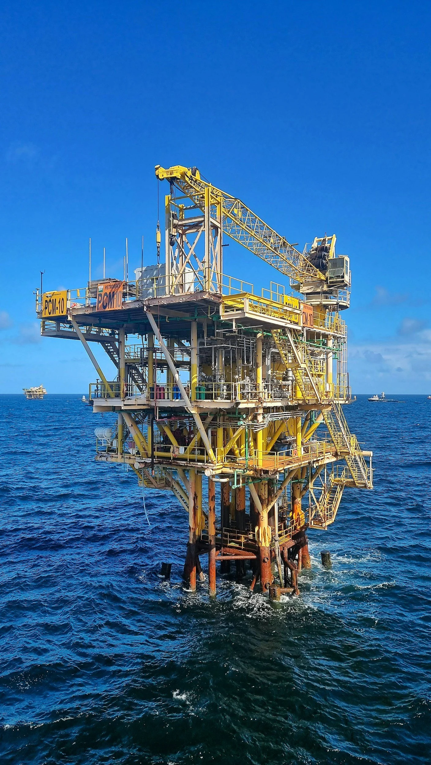 Offshore oil rig in the ocean with a blue sky.