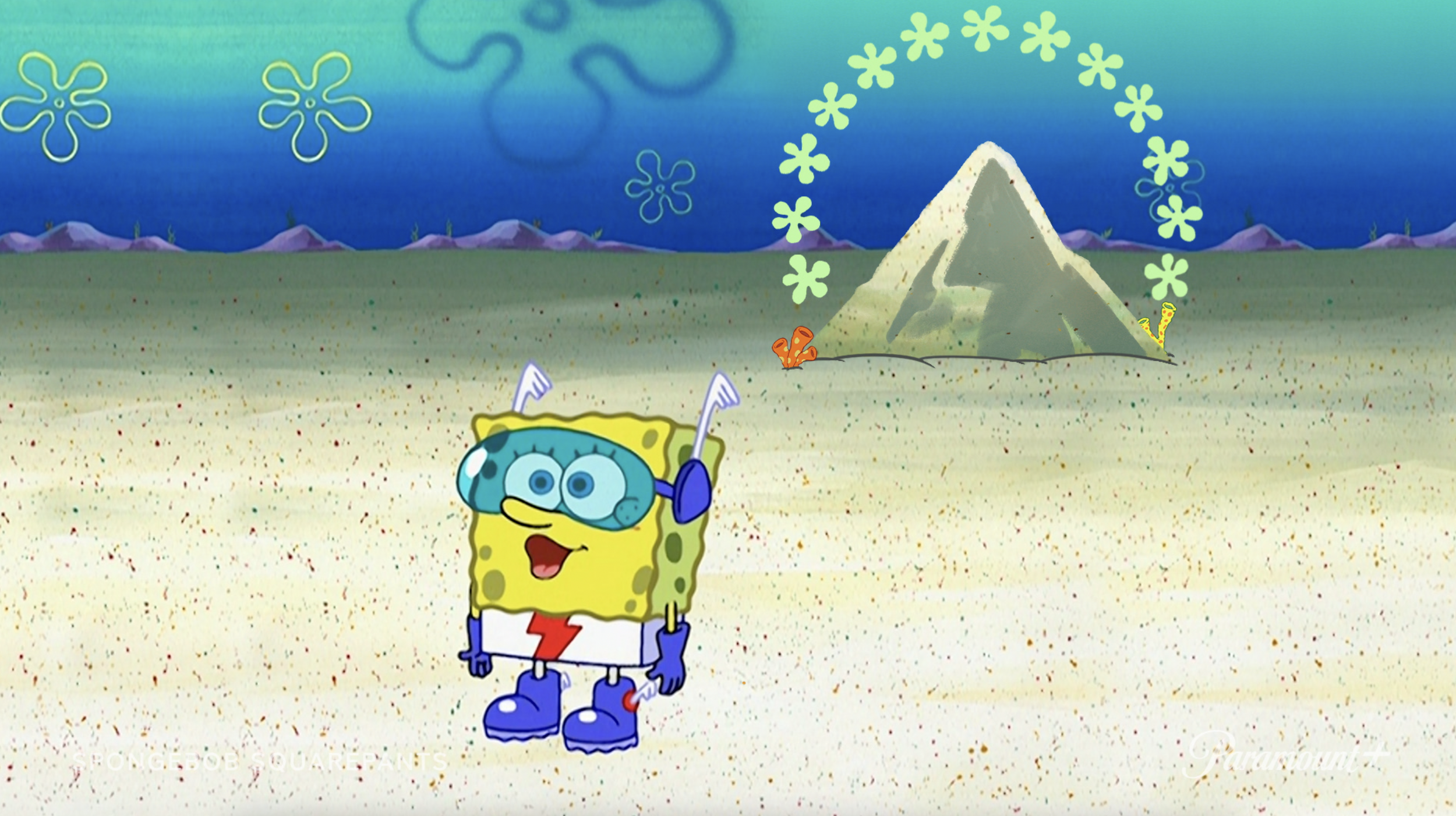 SpongeBob standing next to the Paramount Mountain