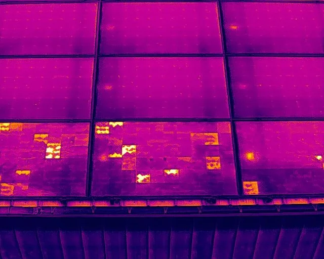 Thermal image of solar panels with some areas showing higher heat, indicating varying temperatures.