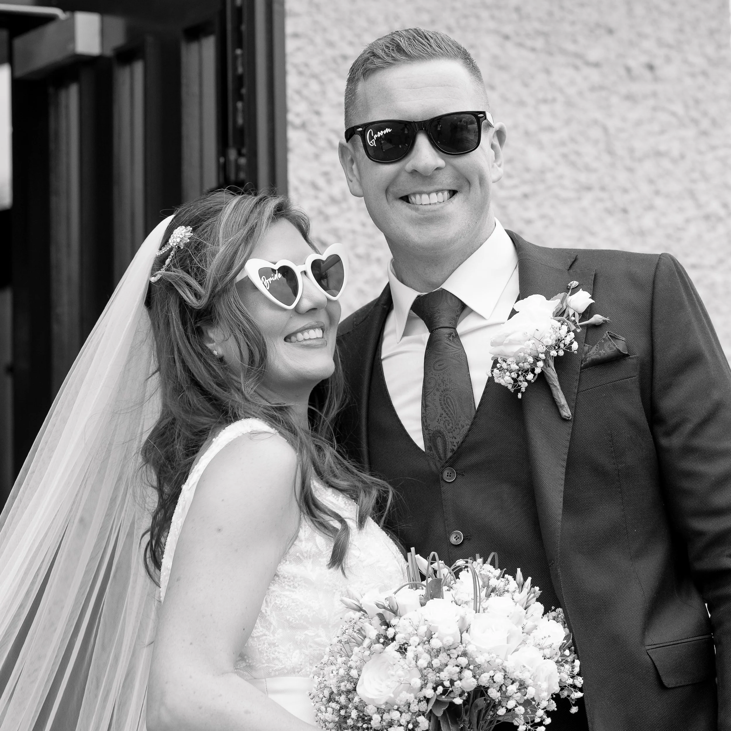 Relaxed, joyful wedding portrait by Tara Woods Photography — bride and groom smiling in sunglasses, captured in a natural, candid style