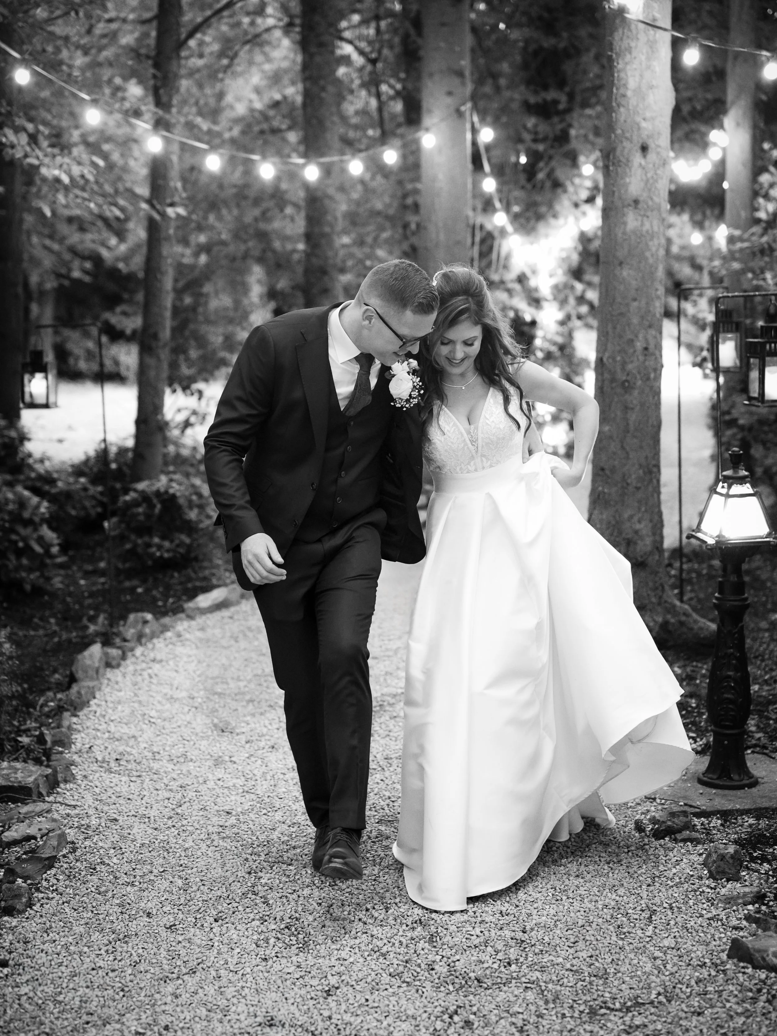 Documentary‑style wedding photography in Ireland — candid black‑and‑white moment of a couple walking together, captured by Tara Woods Photography.