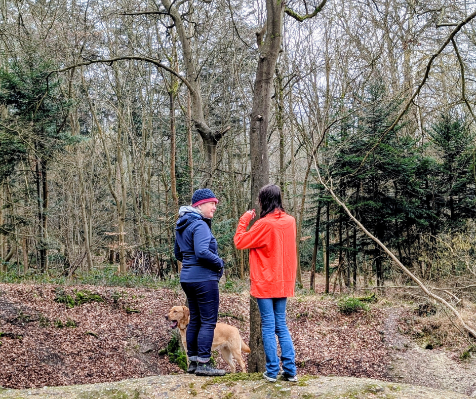 A lady listening to an 18 year old who has anxiety, during a woodland walk in Wallingford.