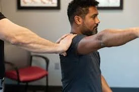 A man receiving muscle release on his shoulder from a medical professional