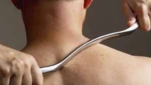Person receiving muscle scraping on their shoulder