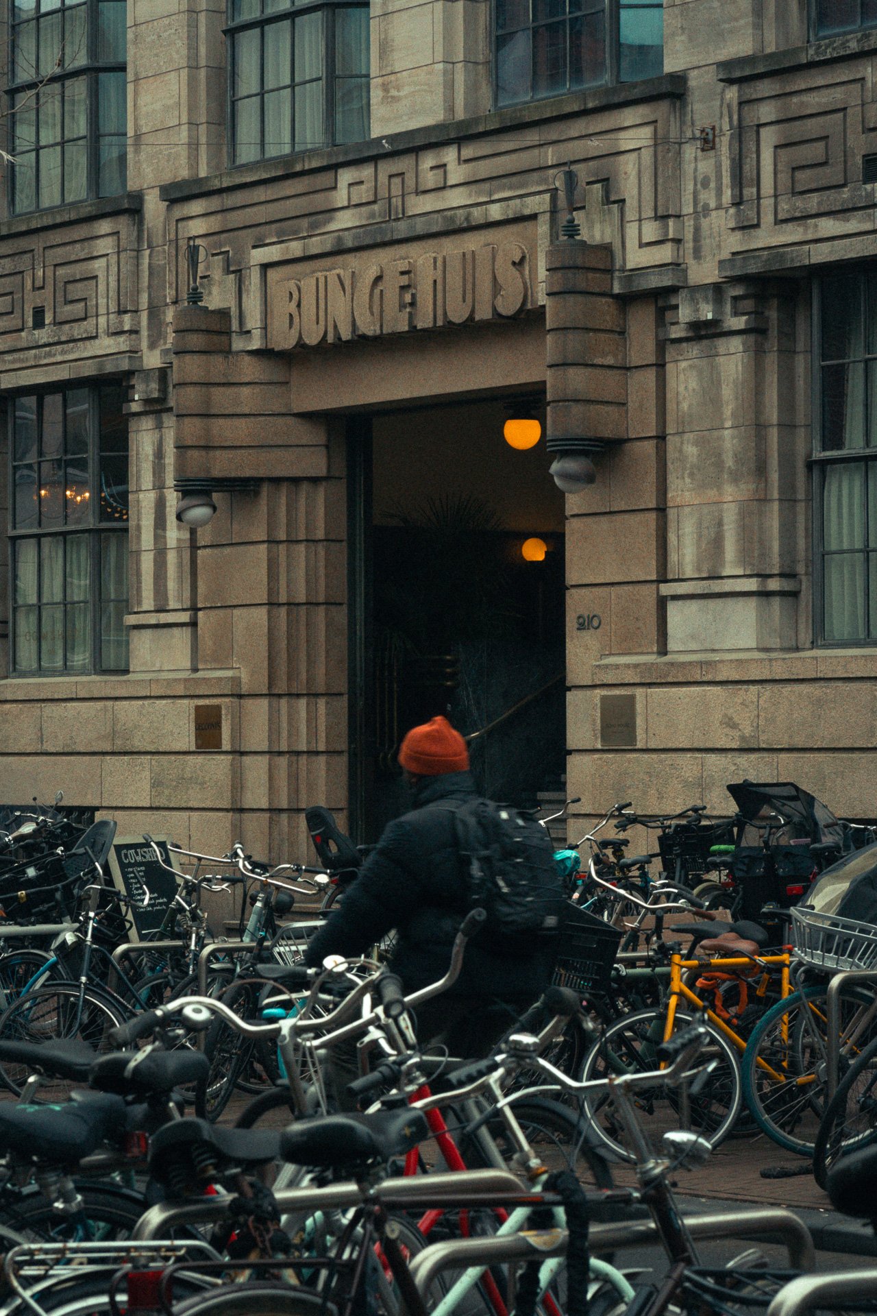 Urban street entrance with bicycles, cinematic city-hotel vibe for boutique stays and destination storytelling