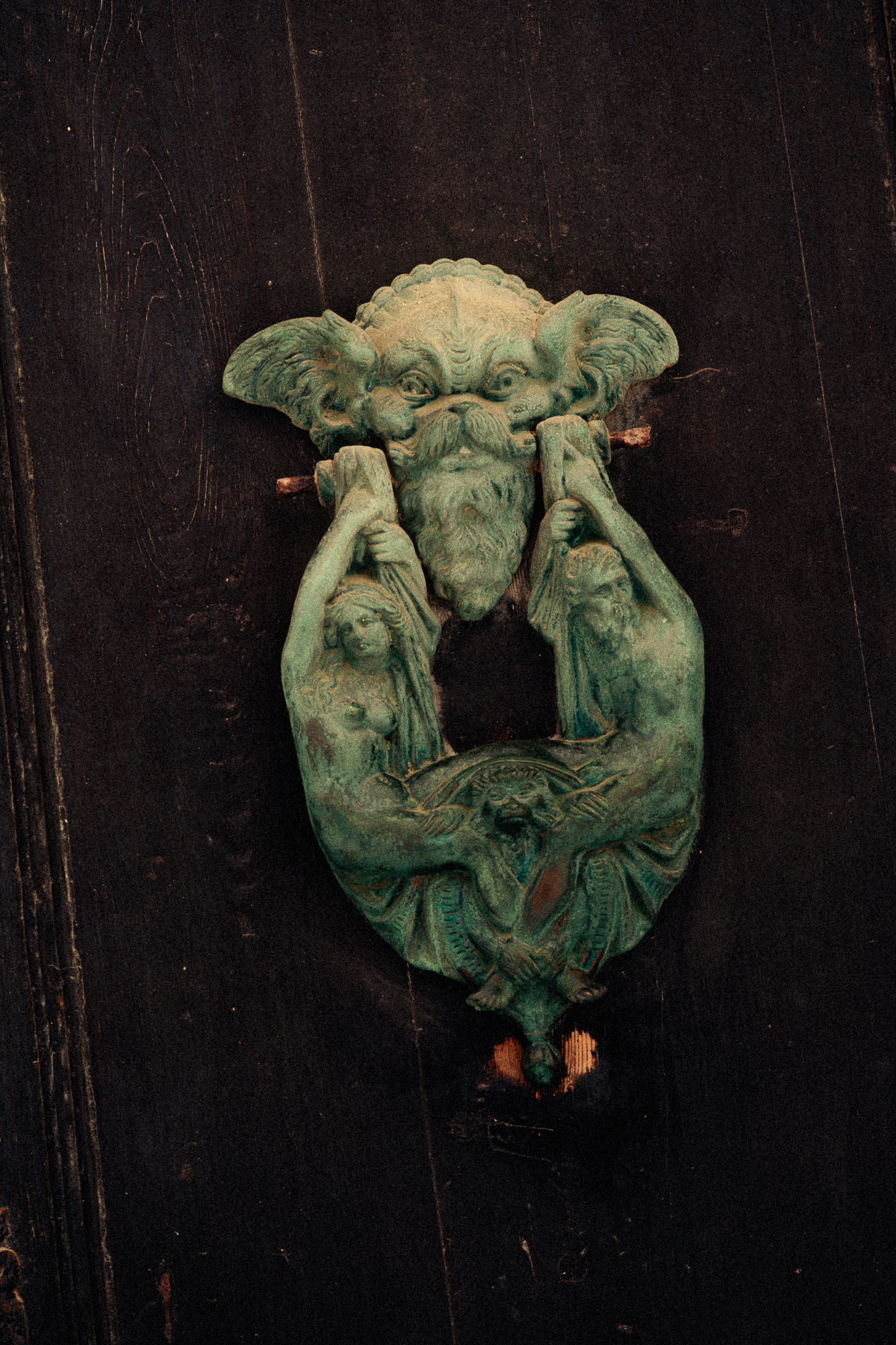 Textured green sculpture detail on dark background, artistic decor close-up for design hotel visual identity