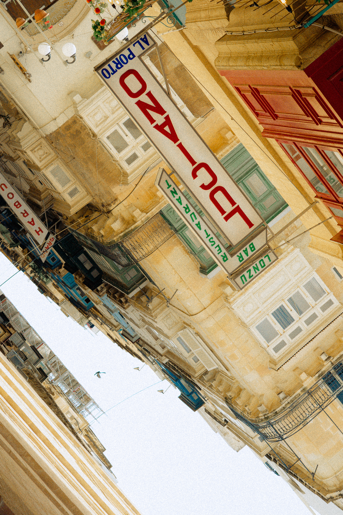 Tilted urban facade with signage, graphic street texture for design-led hospitality and destination storytelling