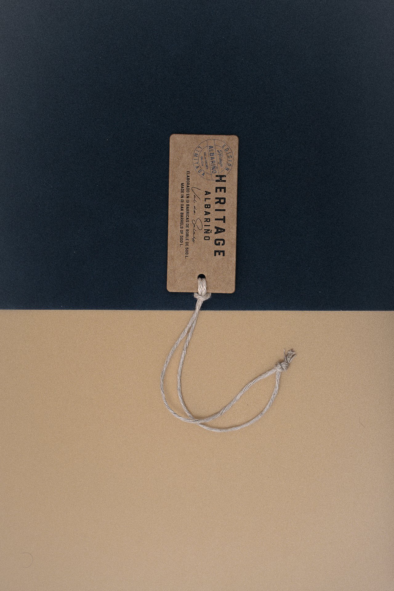 Minimal product tag and cord on two-tone background, premium detail styling for luxury brand visuals