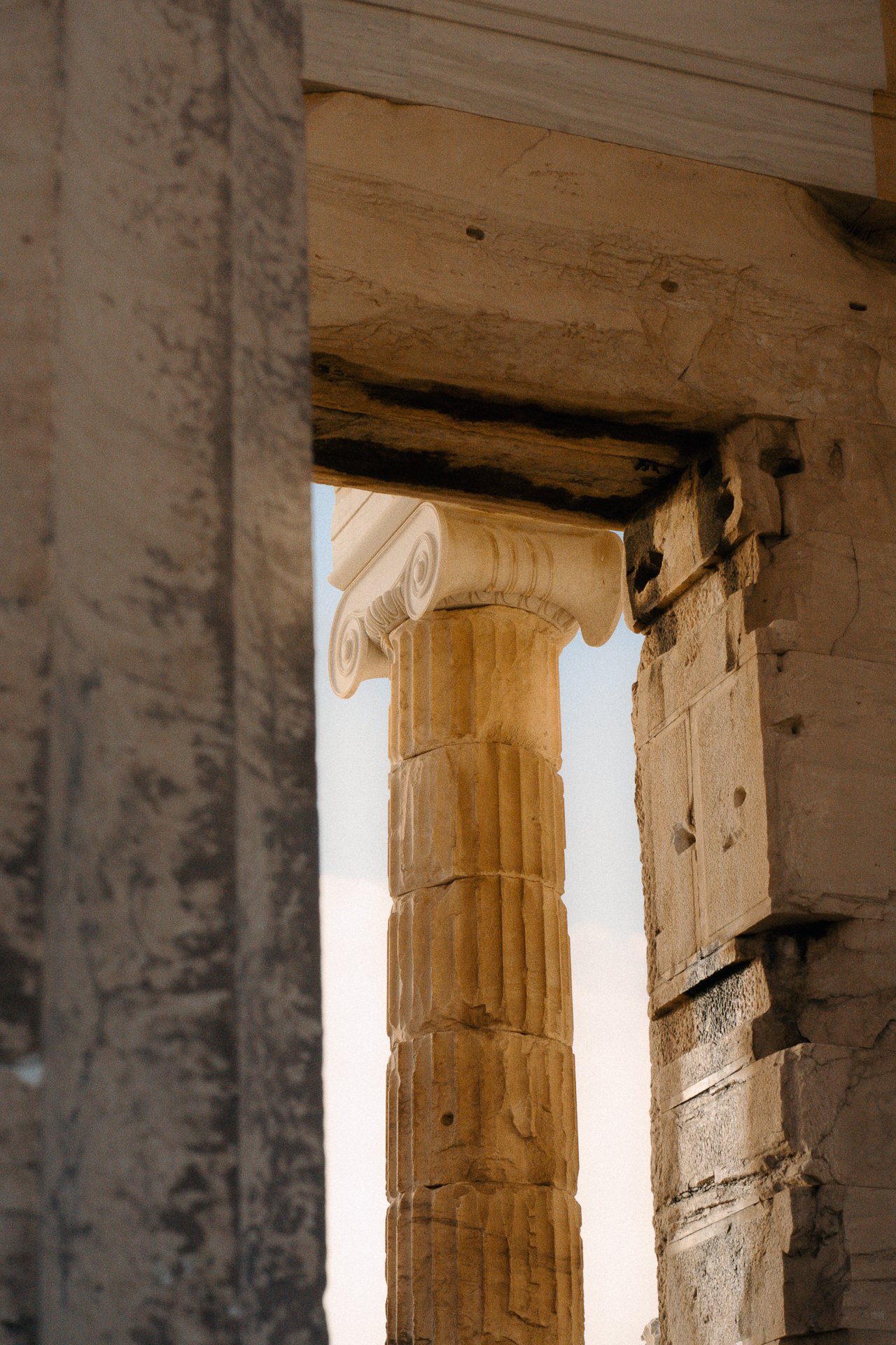 Classical column detail in warm light, architectural texture for design hotels and luxury editorial content