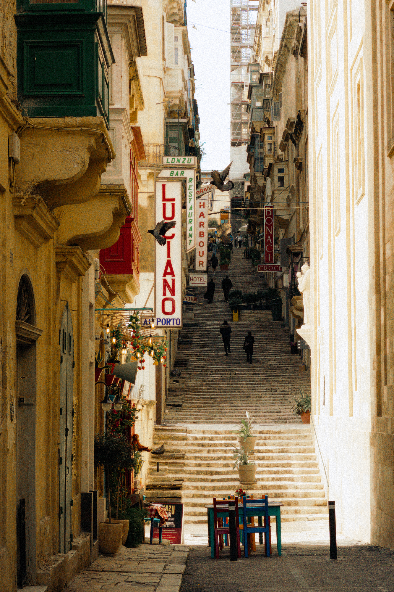 Sunlit stone staircase with urban signage, cinematic street scene for destination hotels and slow travel content.