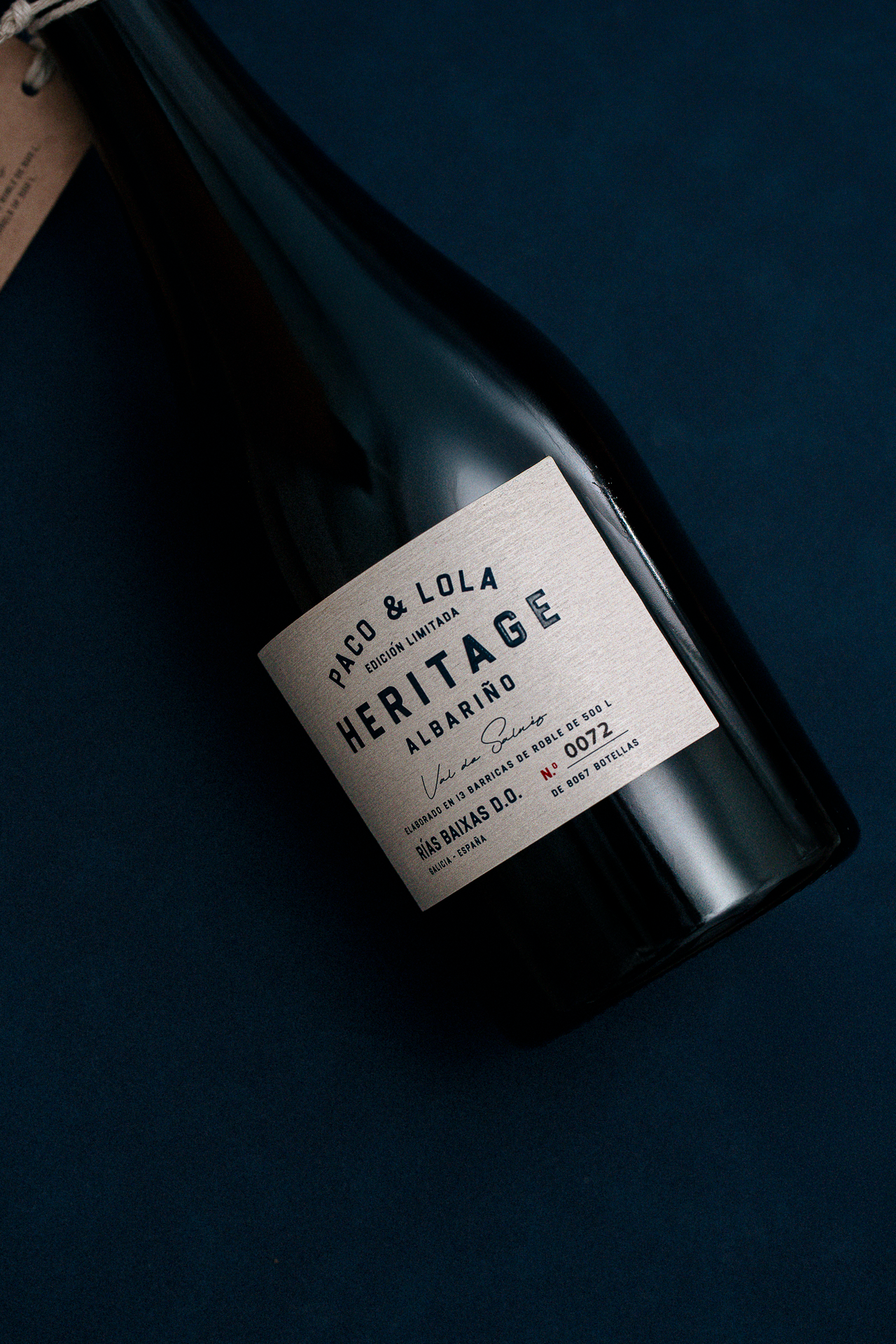 Dark wine bottle close-up with label detail, premium beverage styling for luxury hospitality and restaurants