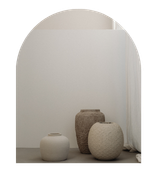 Three textured ceramic vases of different sizes on a black surface against a plain white wall.