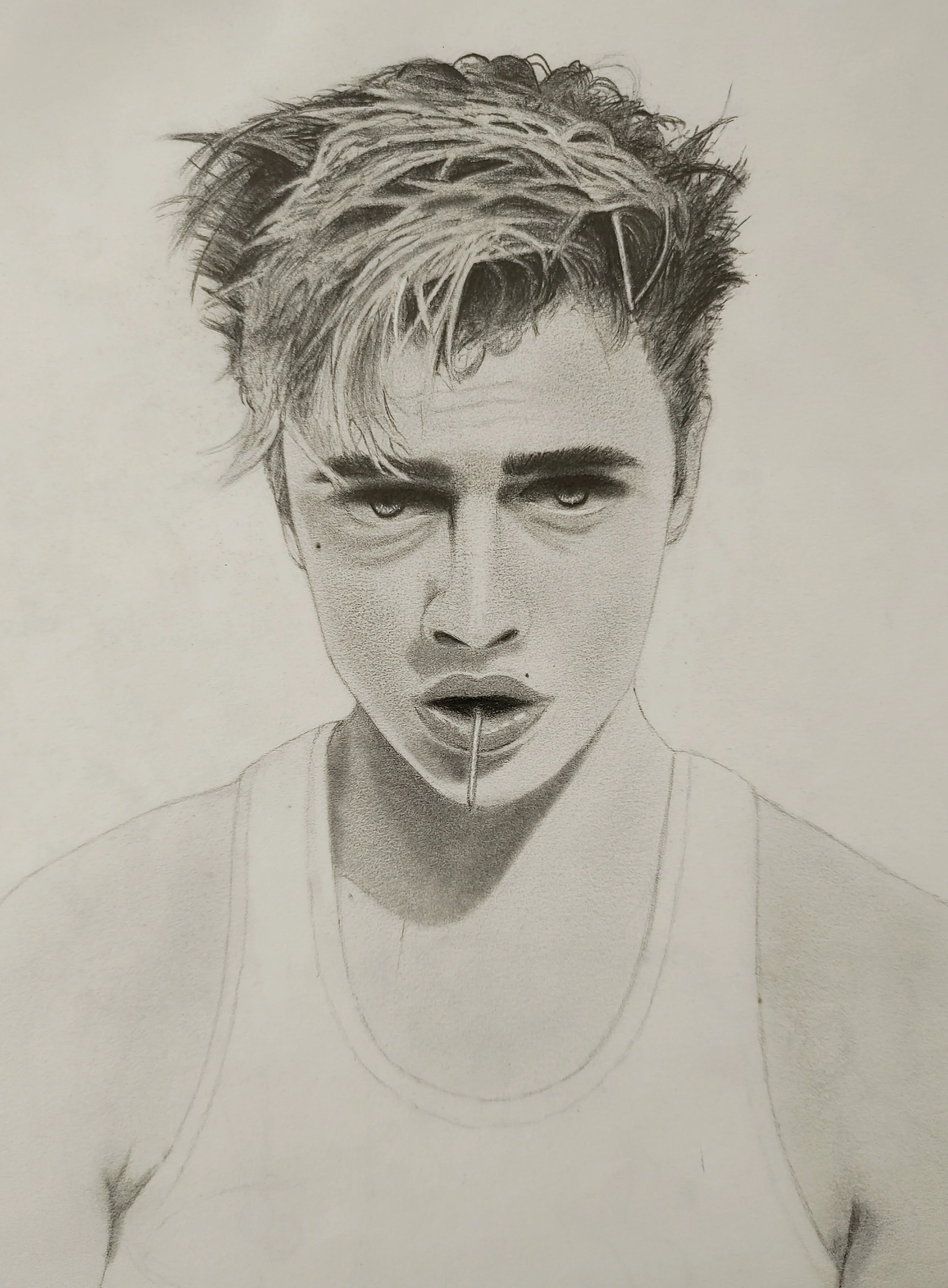 Personal artwork.
Graphite pencil on paper.
Artwork of model Lucky Blue Smith in a white tank top with messy hair and a toothpick in his mouth.
Reference used was an old editorial photo.