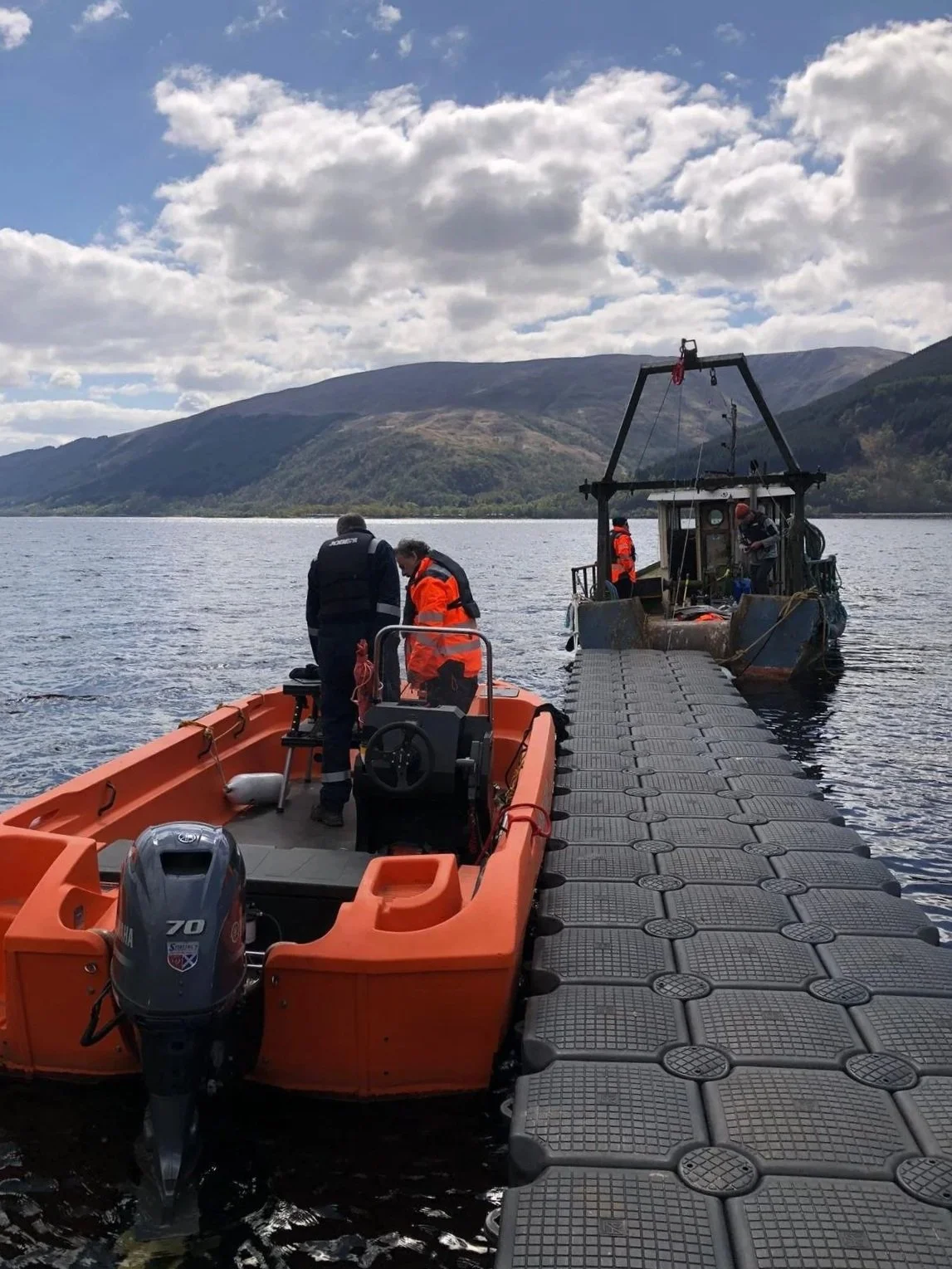 Two men working on a safety boat