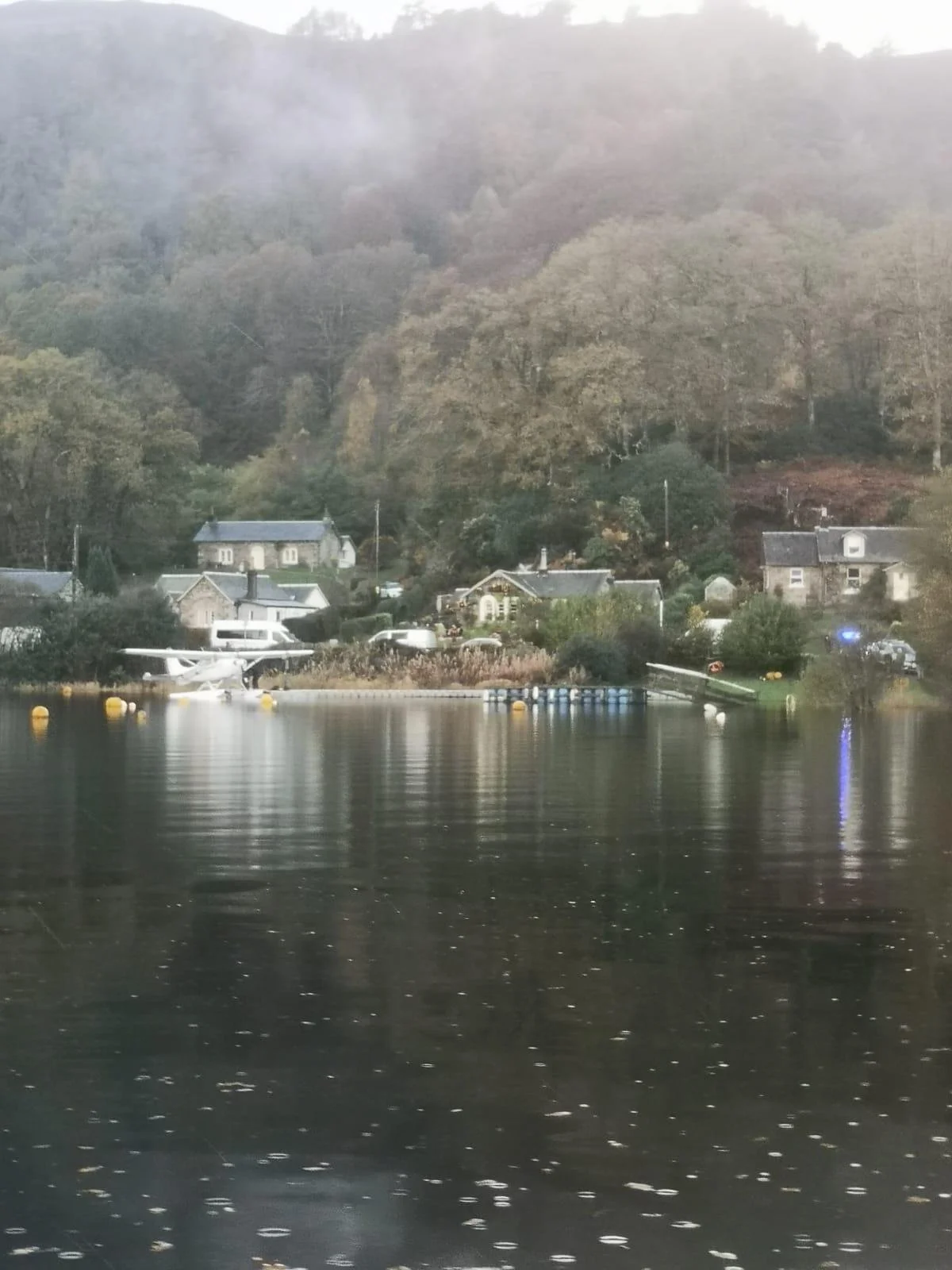 Seaplane landing next to a floating dock
