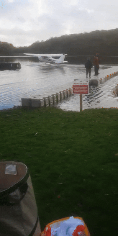 Seaplane taking off next to floating platoon