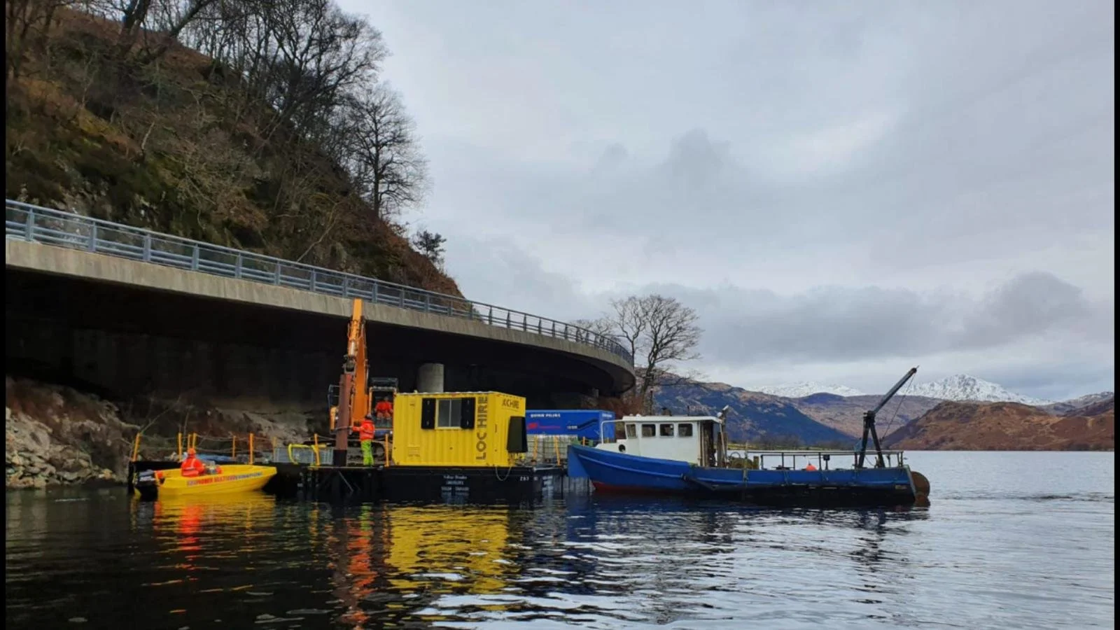 Floating barge with construction crew on Loch Lomond