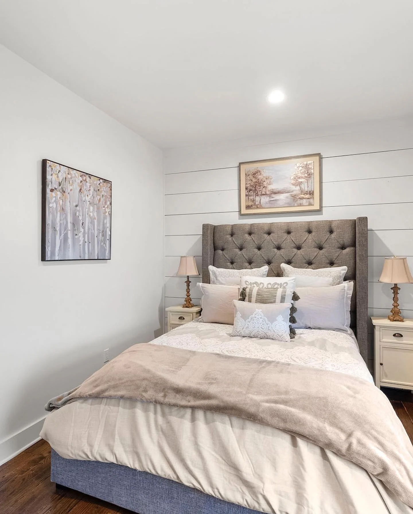 pacious queen bedroom with a tufted headboard, crisp white bedding, and soft neutral decor in a peaceful Ball Ground, Georgia vacation rental.