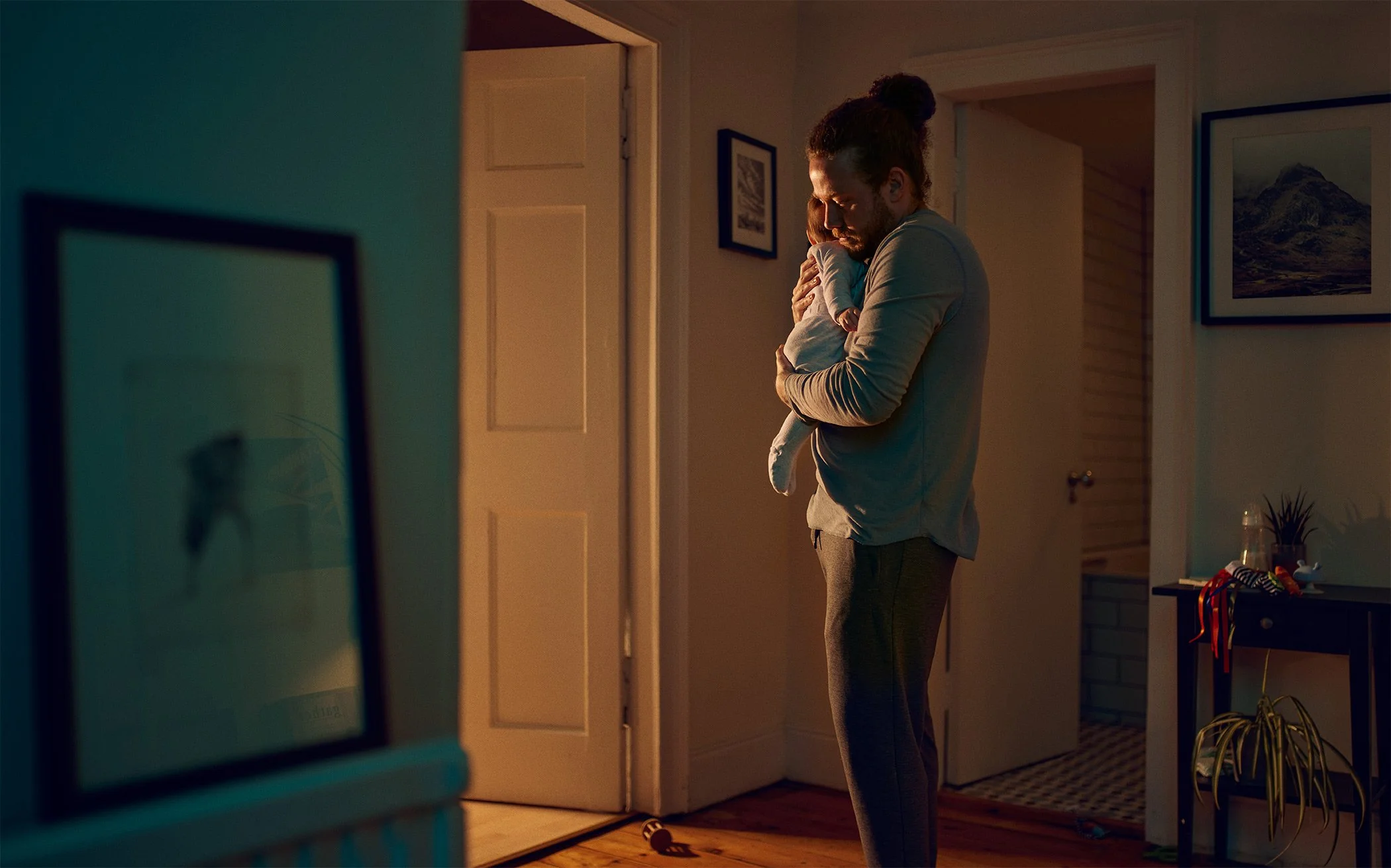 David Boni lifestyle advertising photography — man  and baby home for Pharmaceutical Campaign