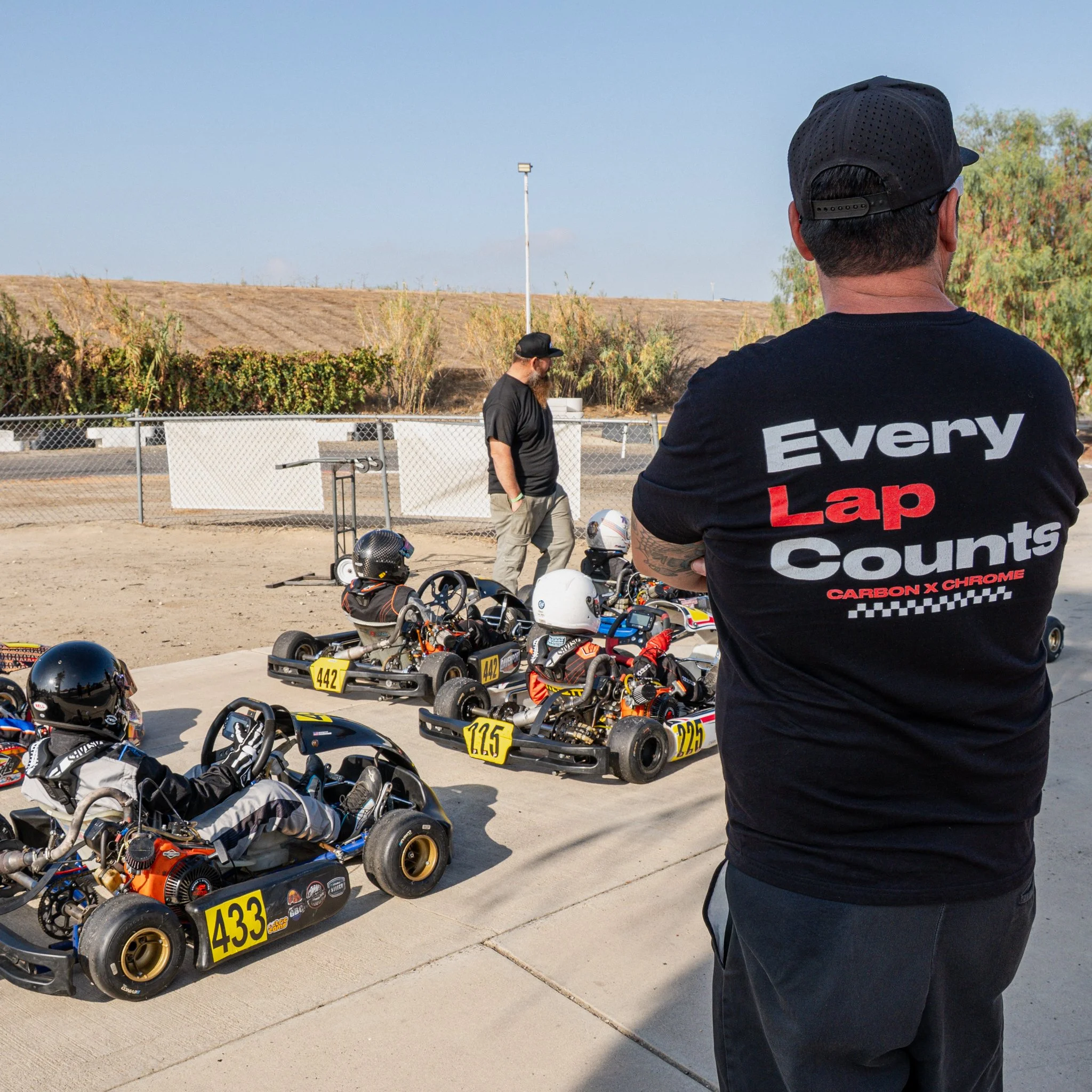 Every Lap Counts Carbon x Chrome karting shirt at the race track