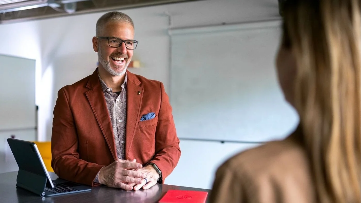 A photo of business owner Preston True communicating with an employee to build team trust.