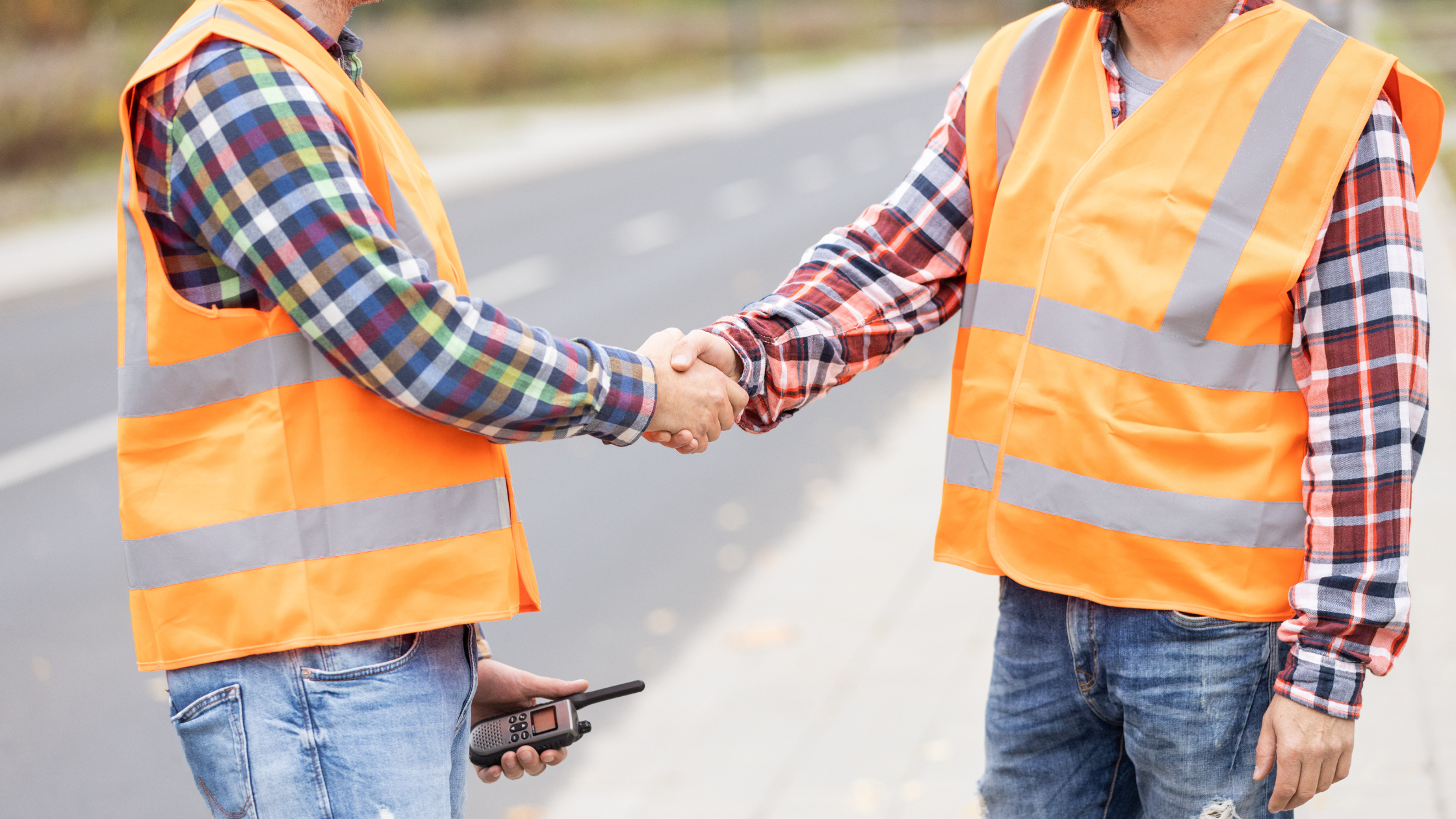 two construction workers shaking hands over a decision to improve market position