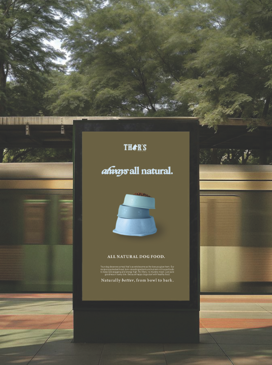 A digital advertisement board for Thors dog food at a train station, featuring a stack of three blue dog bowls, with the text "Thors always all natural" and "All natural dog food." in a green background.