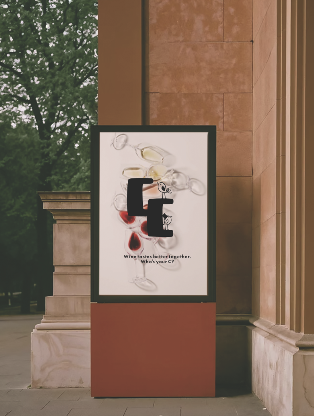 Advertising poster outside a building featuring images of wine glasses with red and yellow liquid, celebrating wine pairing with the letter 'C' and the text 'Wine tastes better together. Who's your C?'.