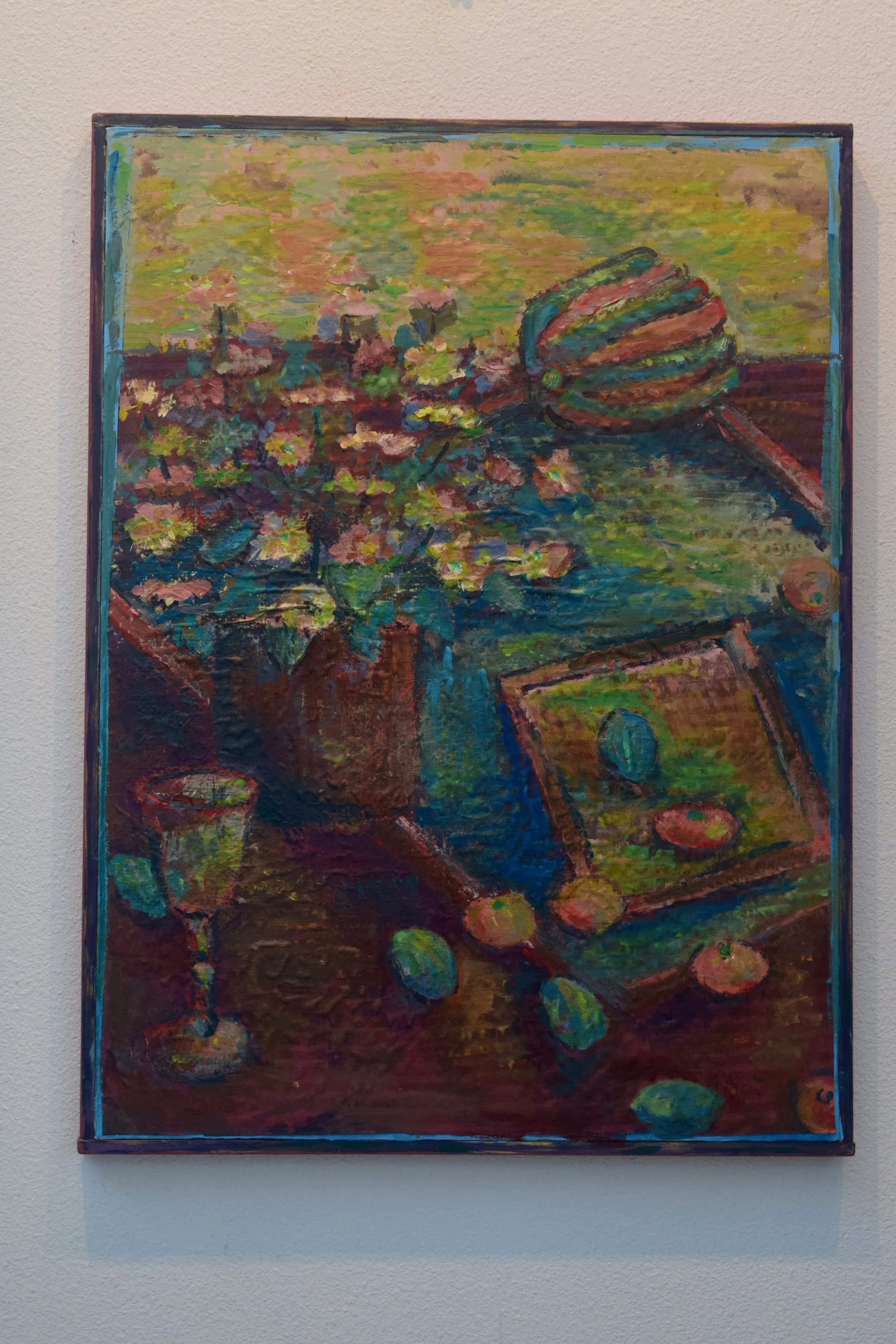 An impressionist painting of a still life scene with a vase of pink flowers, a striped hat, a framed picture, a goblet, and scattered lemons on a wooden surface.