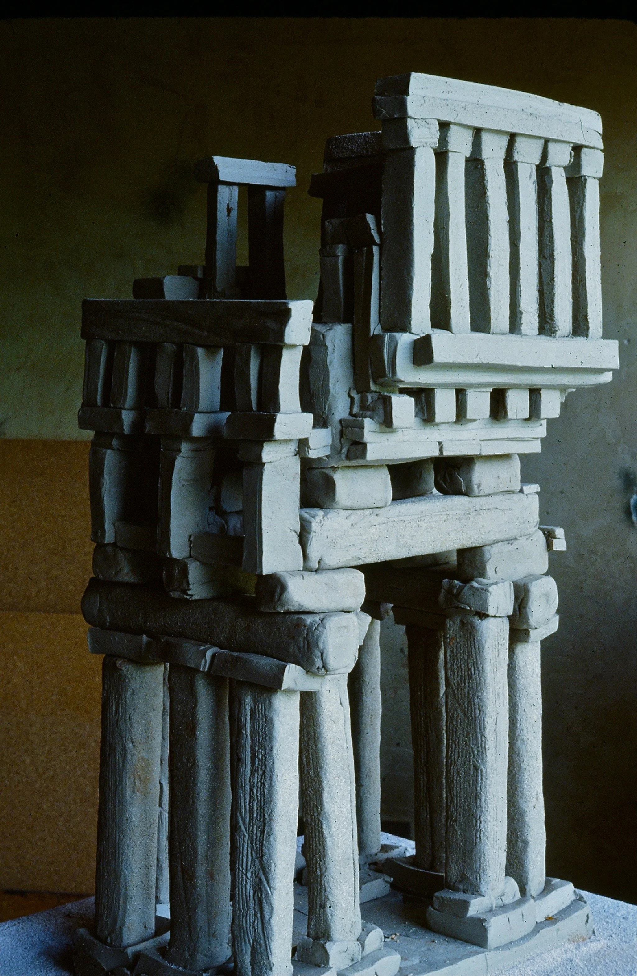 A structure made of various stone and wood blocks stacked together, resembling ancient ruins or a sculpture.