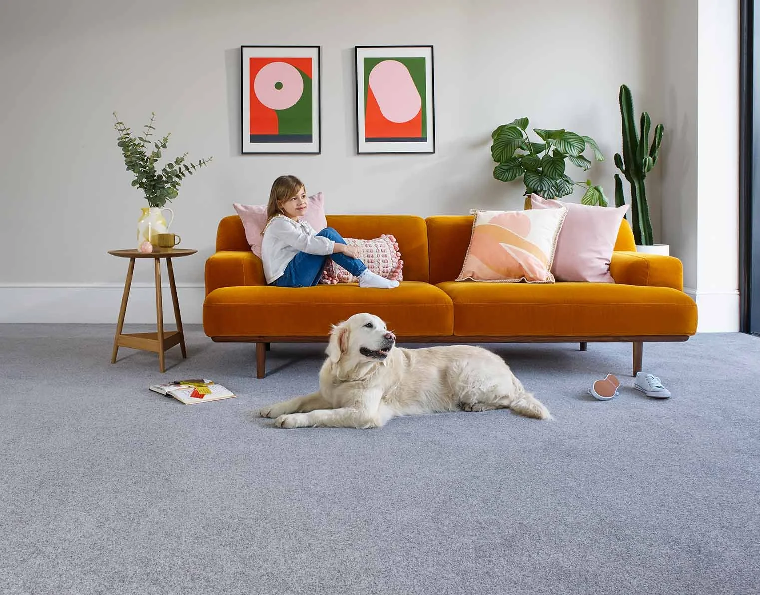 A girl relaxing with her dog on easy clean carpet - leads to more information about the types of carpets available.