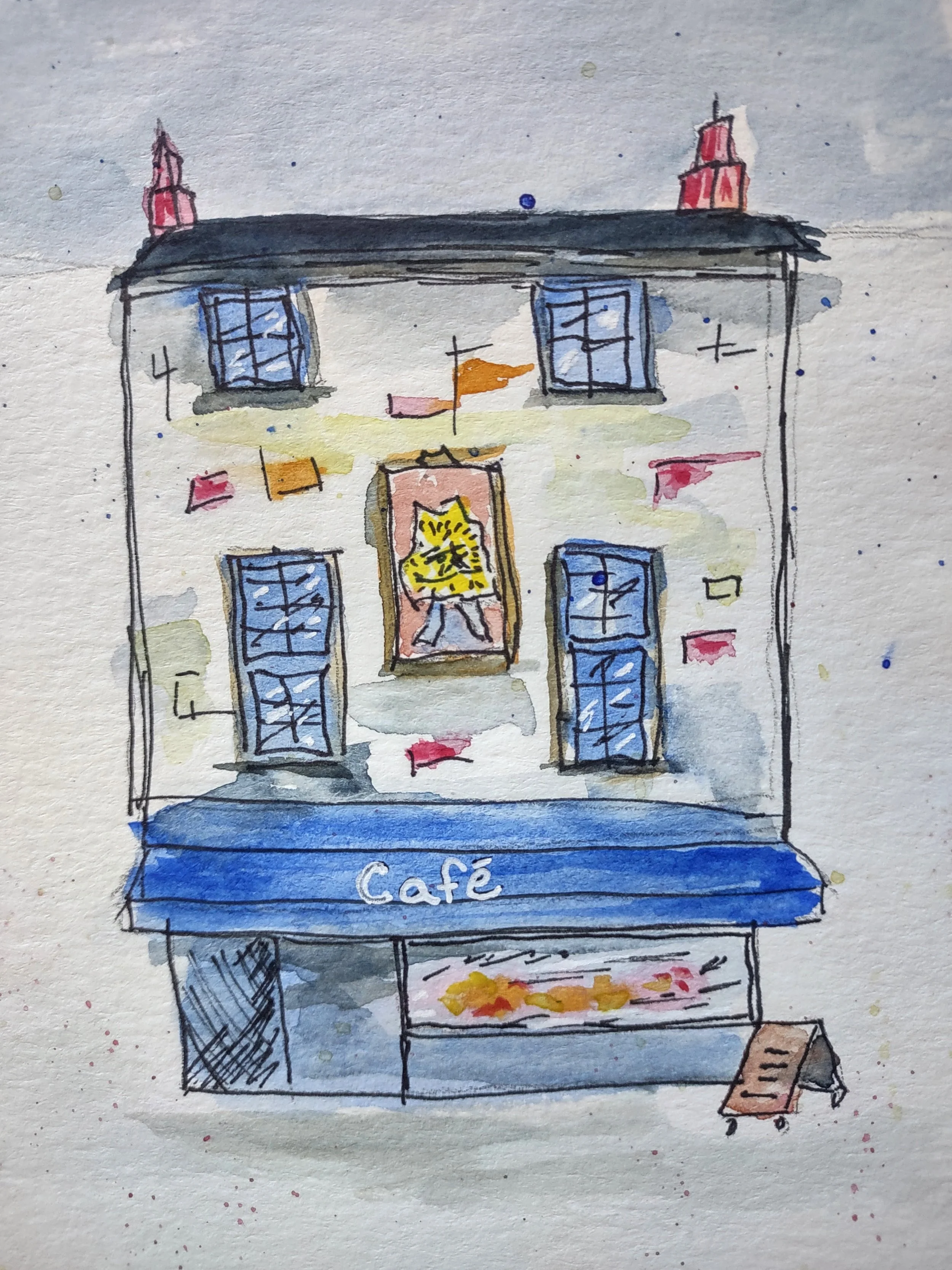 A watercolor sketch of a multi-story café building with blue windows, a sign that reads 'Café', and a small food cart outside.