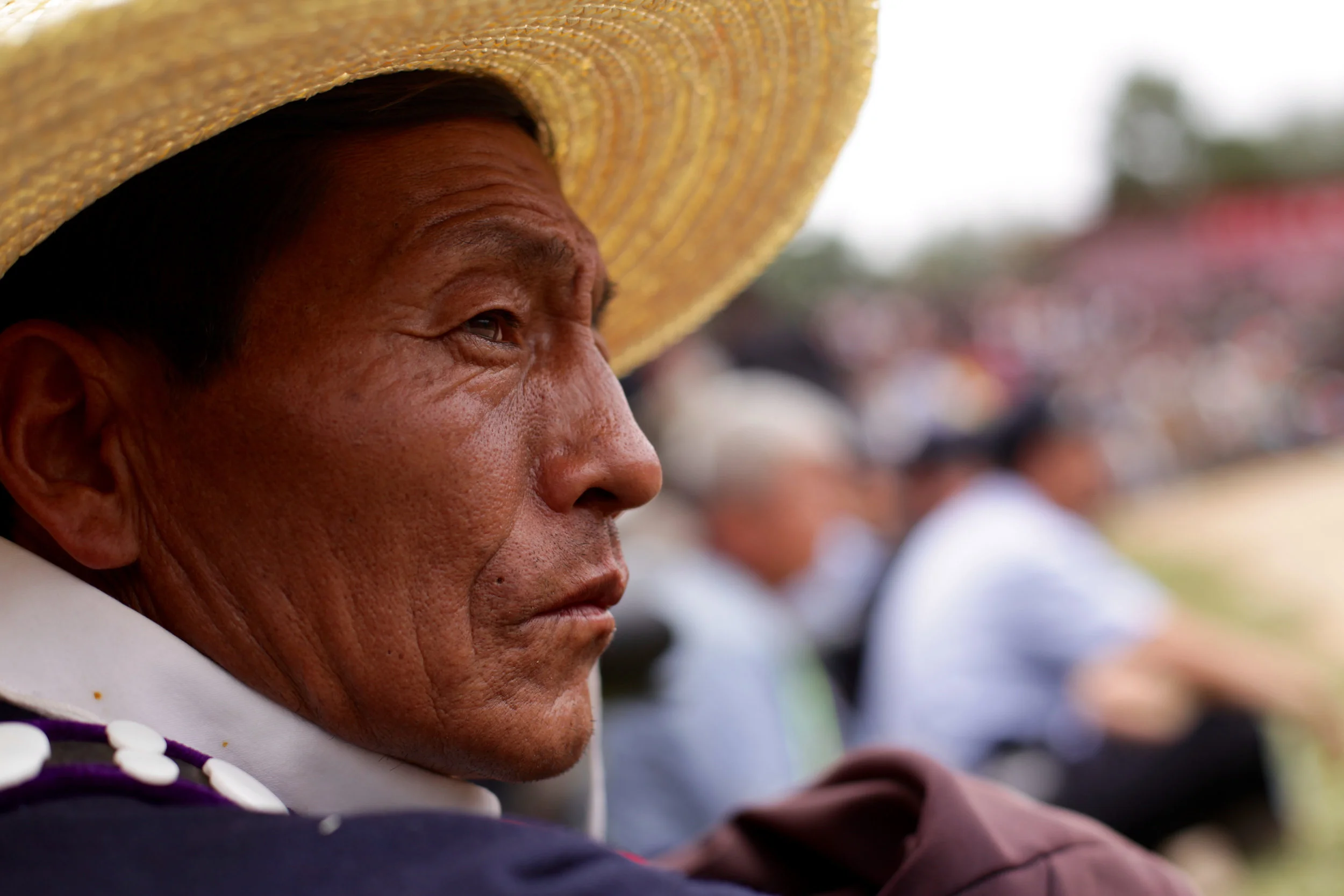 An Yi man watches horse races during Torch Festival celebrations in Liangshan prefecture, Sichuan province, China, July 2016 (1).jpg