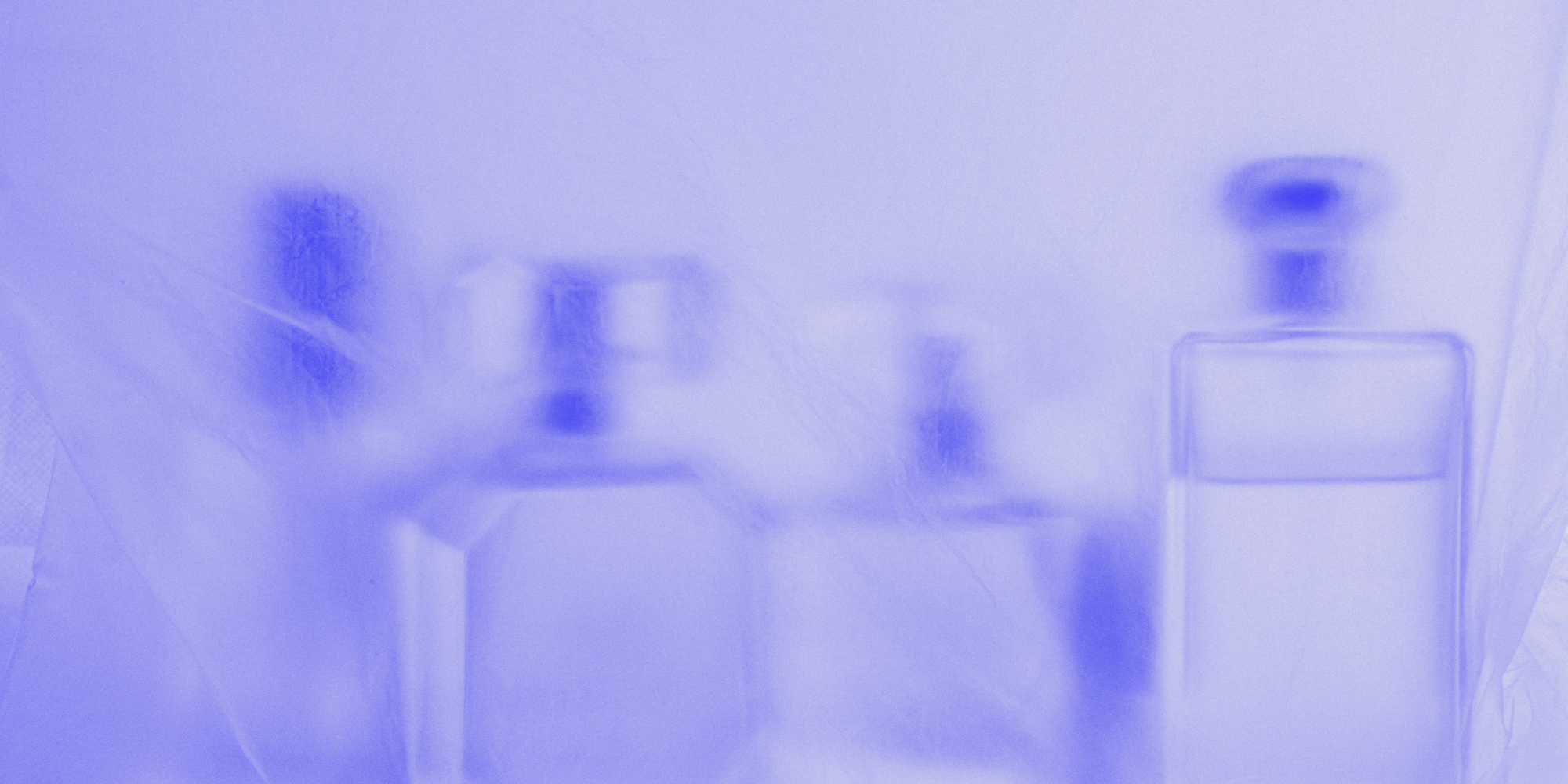A blurred photo with blue tint showing a part of an office or medical environment, including some shelves and possibly medical or office equipment.