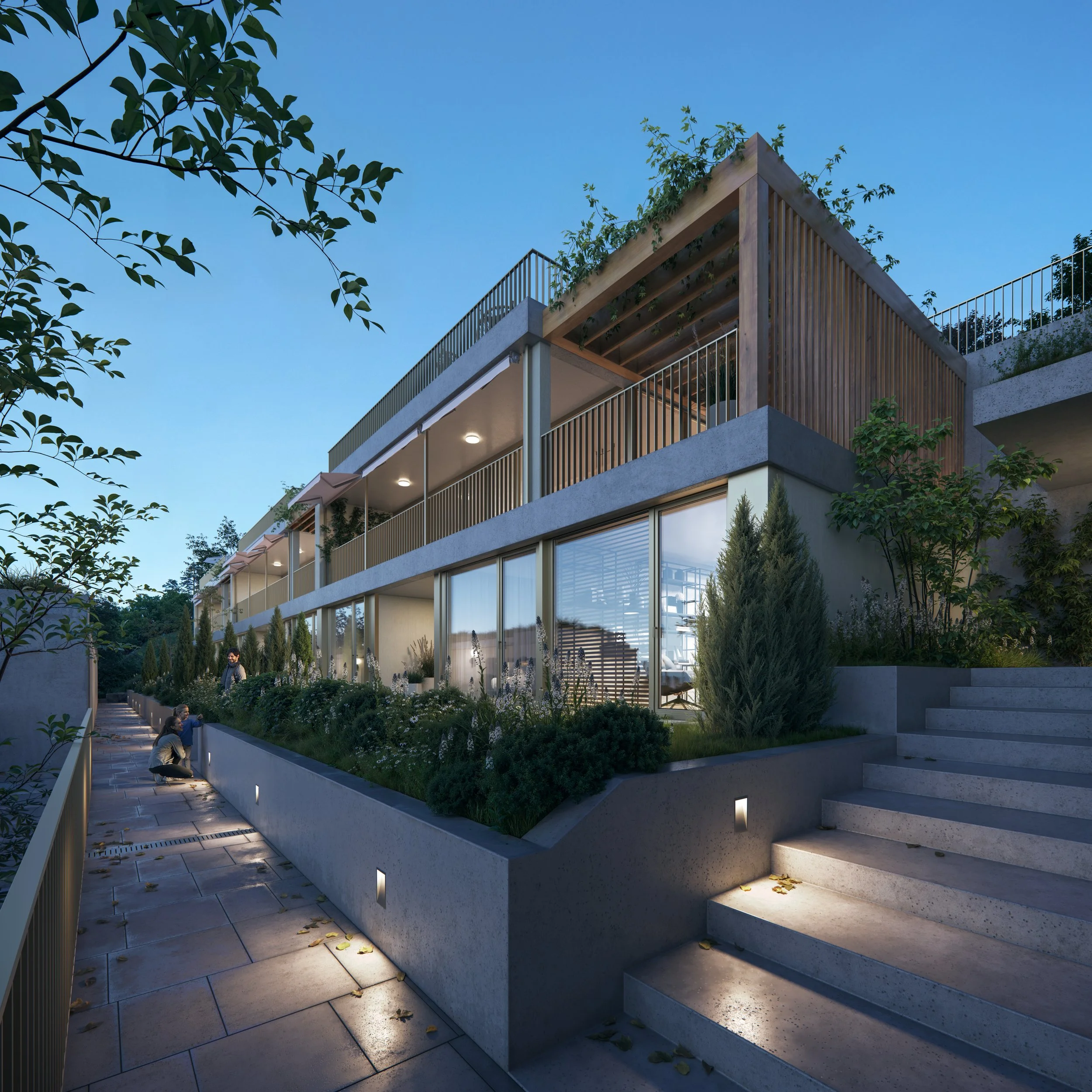 Modern multi-story residential building with large glass windows, outdoor greenery, and stairs leading to the entrance, illuminated by exterior lights at dusk.