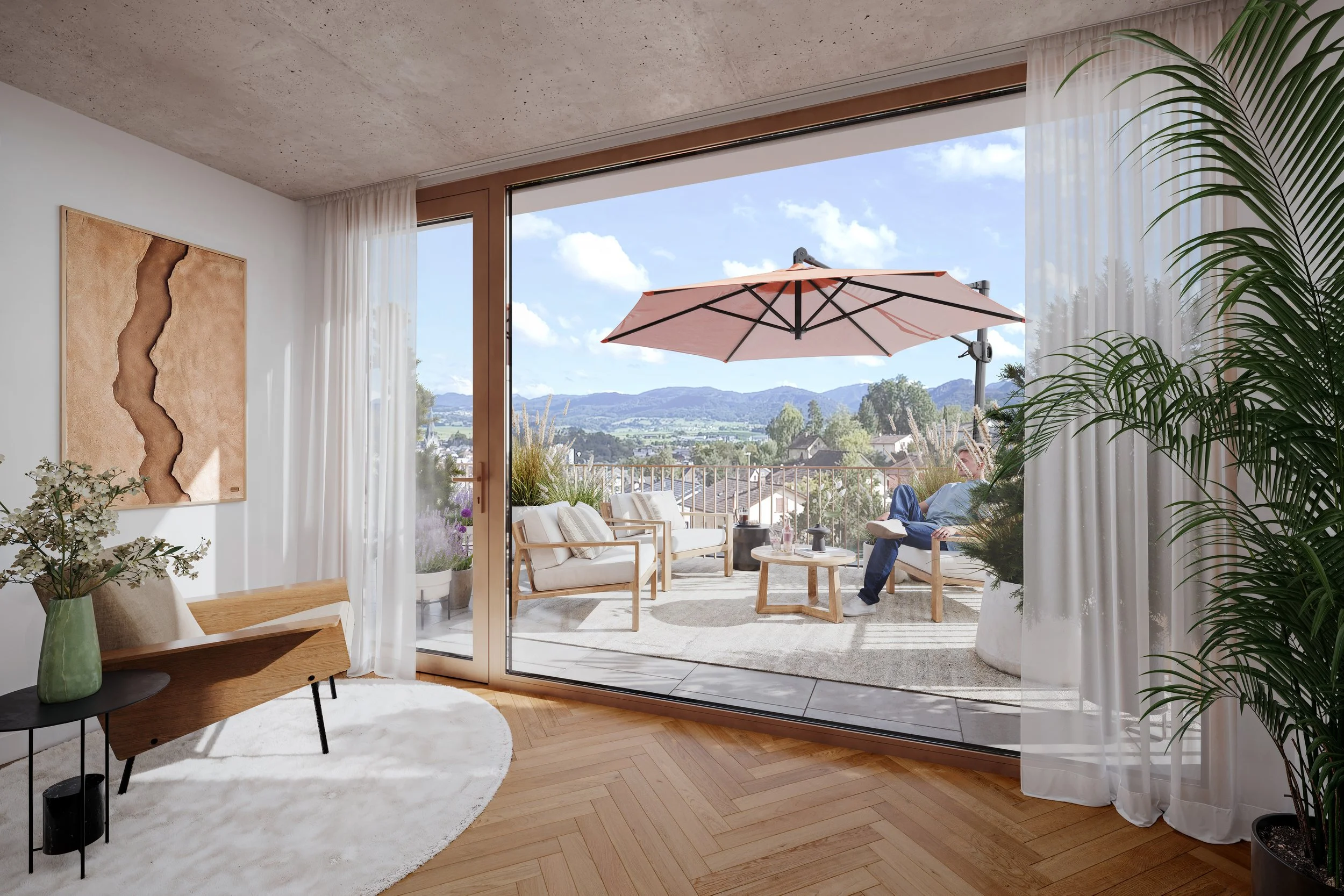 Living room with large sliding glass doors that open to a balcony with outdoor furniture, an umbrella, and a view of distant mountains and houses under a partly cloudy sky.