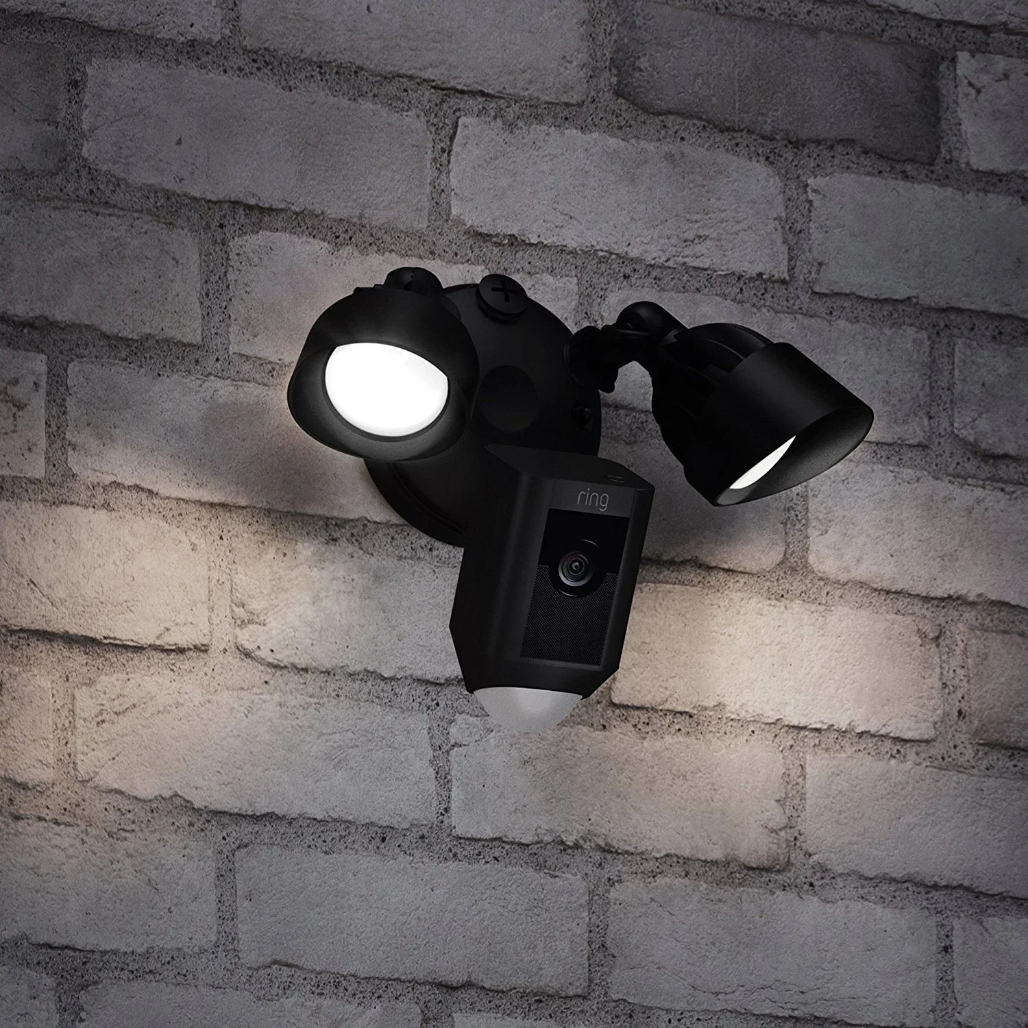 Security camera mounted on a brick wall with dual adjustable lights.