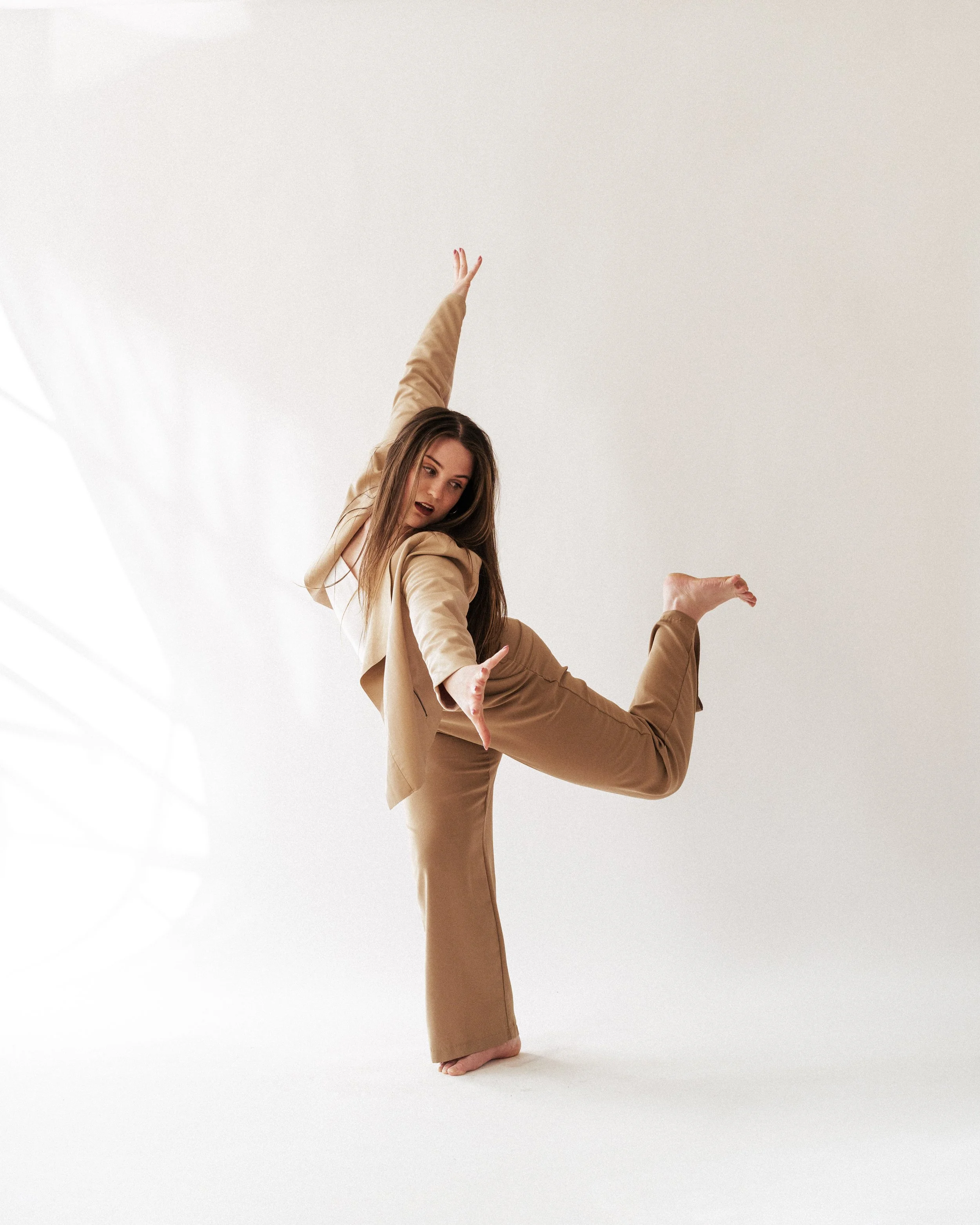 Marissa performing a dance pose on a plain white background.