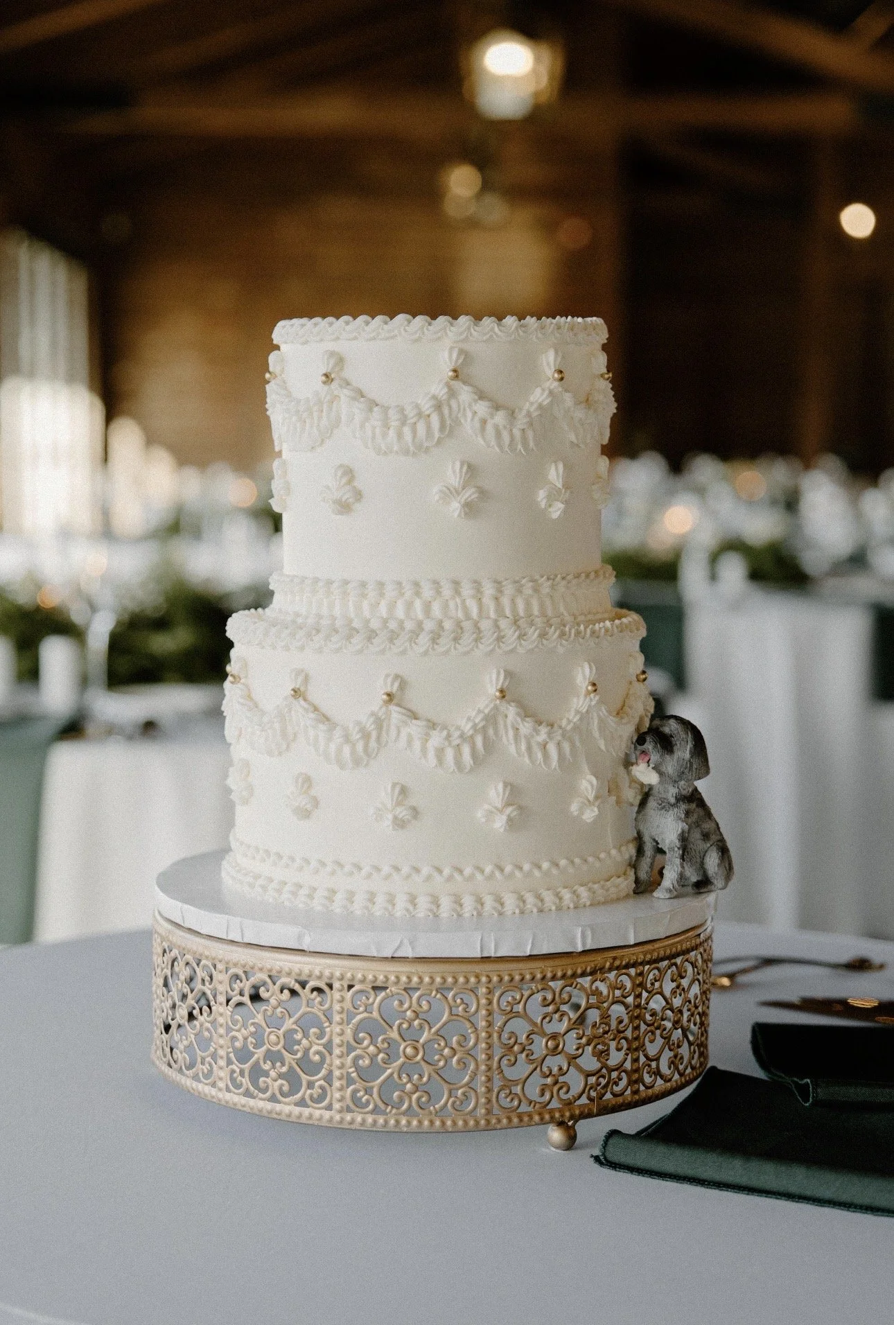 Delaney's white, two-tier wedding cake with a little figurine of her dog Luna.