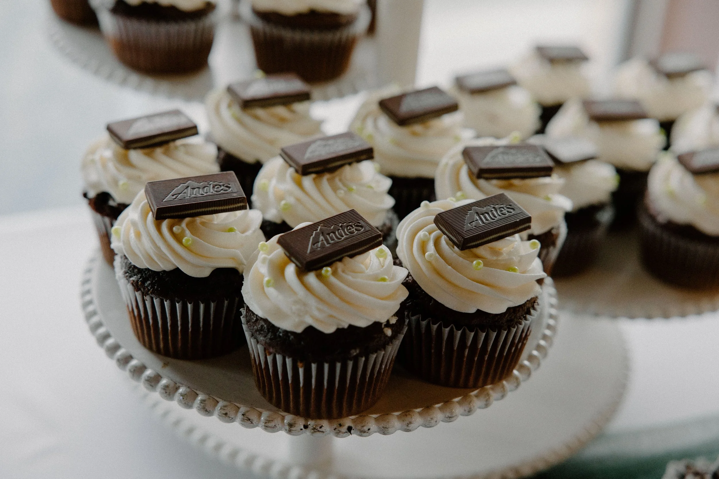 Chocolate cupcakes with vanilla frosting with Andes mint on top.