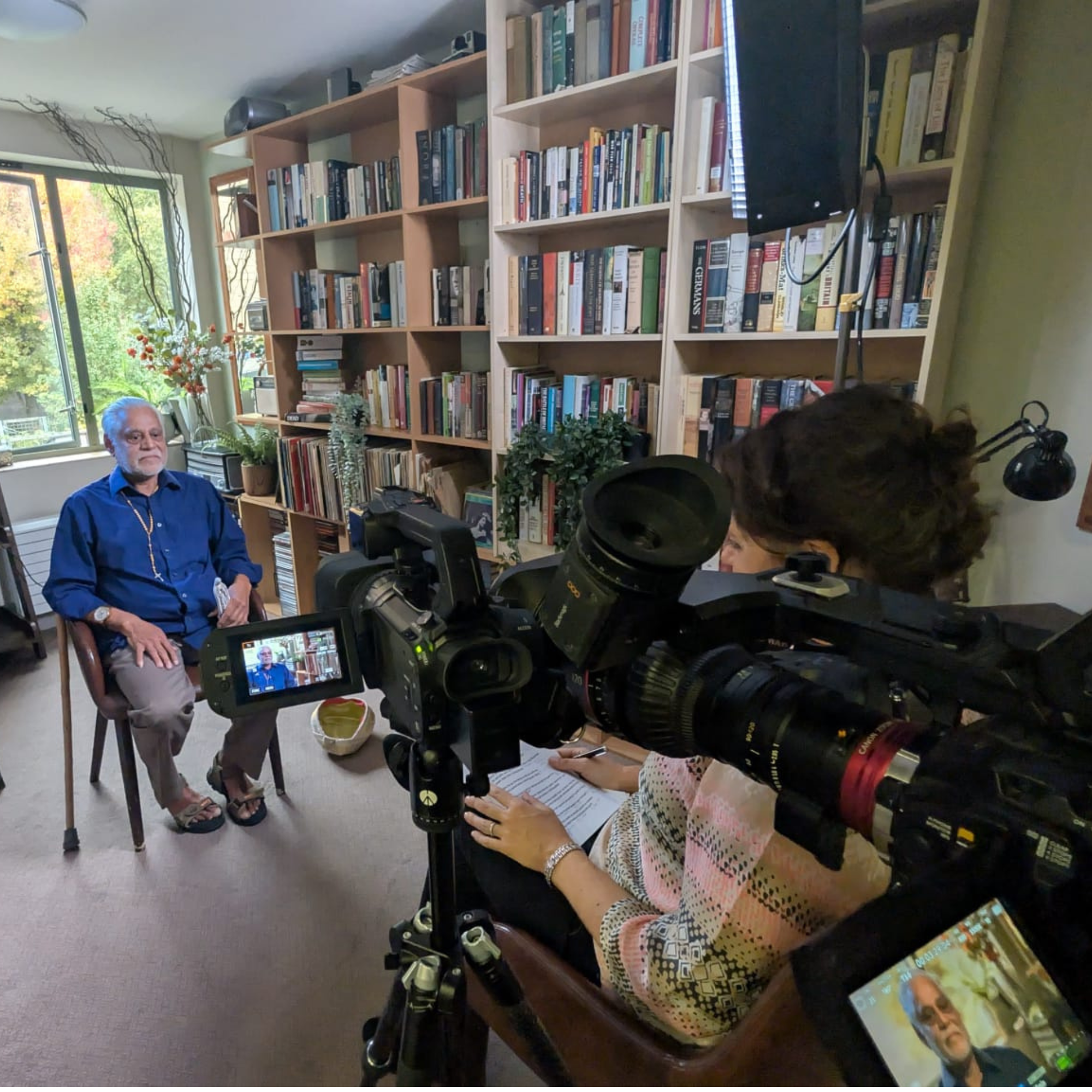 A care home resident is happy and relaxed and enjoying telling his story for a Legacy Film made by Two Friends Films