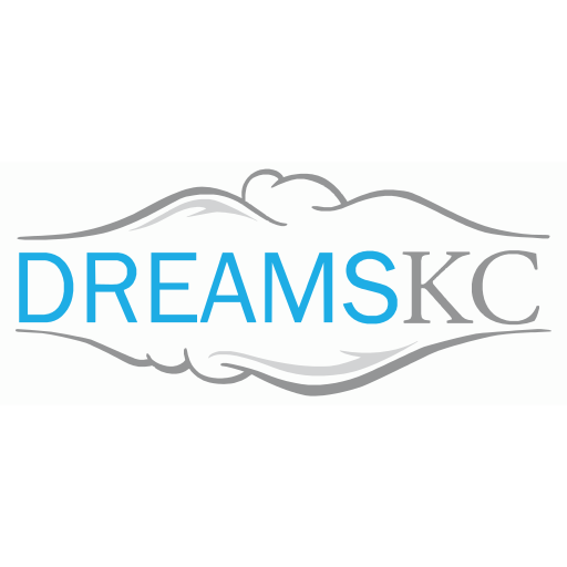 Logo for Dreams KC featuring stylized clouds and mountains in gray, with the text 'DREAMS KC' in blue and gray.